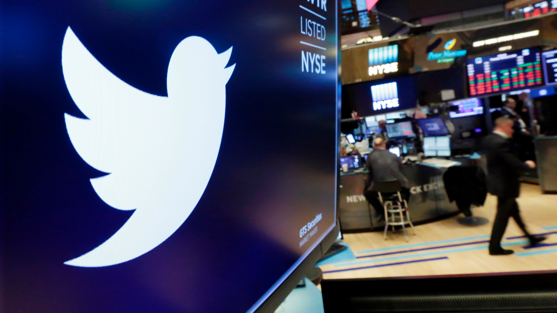FILE - In this Feb. 8, 2018, record photo, a trademark for Twitter is displayed above a trade post on a building of a New York Stock Exchange. (AP Photo/Richard Drew, File)