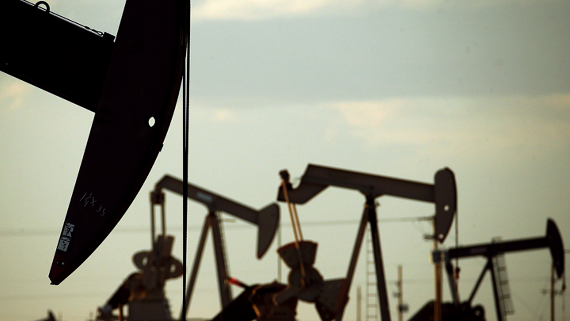 FILE - In this April 24, 2015 file photo, pumpjacks work in a field near Lovington, N.M. With more barrels of oil being pumped monthly from the Permian Basin, New Mexico is among the nation's top producing states. (AP Photo/Charlie Riedel, File)