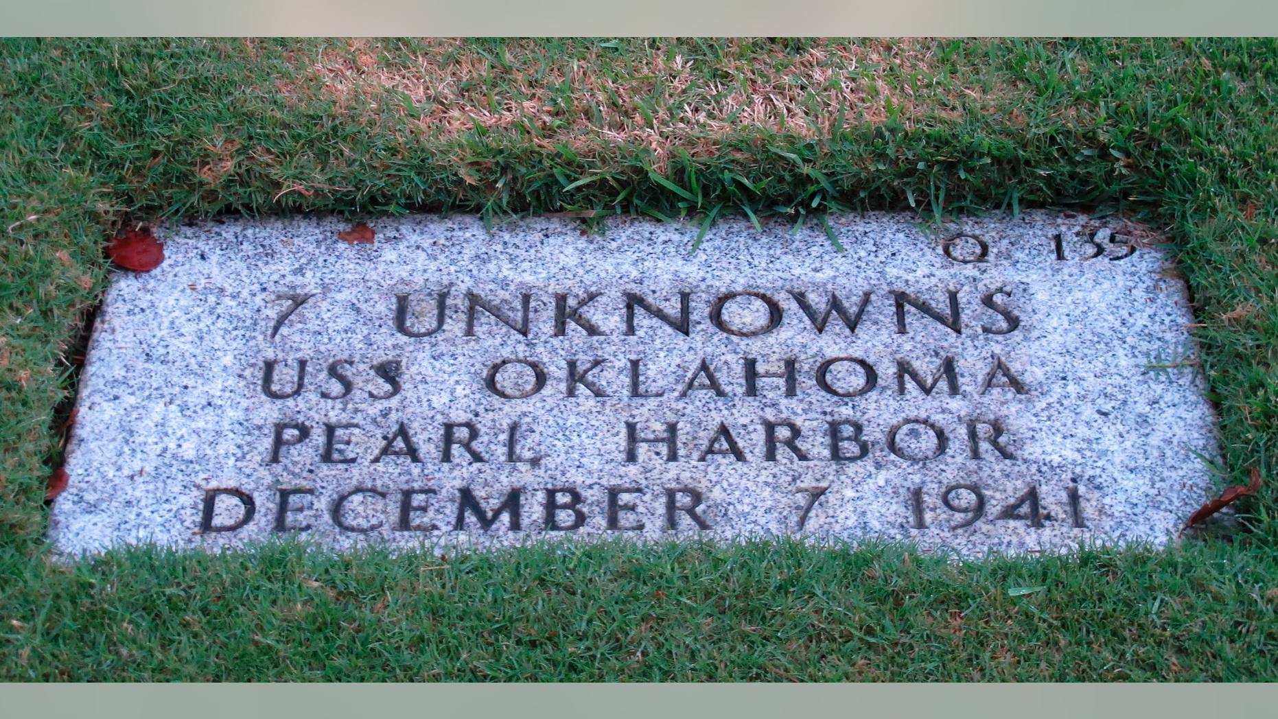 FILE - In this Dec. 5, 2012, file photo, the National Memorial Cemetery of the Pacific in Honolulu displays a gravestone identifying it as the resting place of seven unknown people from the USS Oklahoma who died in Japanese bombing of Pearl Harbor. More than 75 years after nearly 2,400 members of the U.S. military were killed in the Japanese attack at Pearl Harbor some who died on Dec. 7, 1941, are finally being laid to rest in cemeteries across the United States. After DNA allowed the men to be identified and returned home, their remains are being buried in places such as Traer, Iowa and Ontonagon, Michigan. (AP Photo/Audrey McAvoy, File)