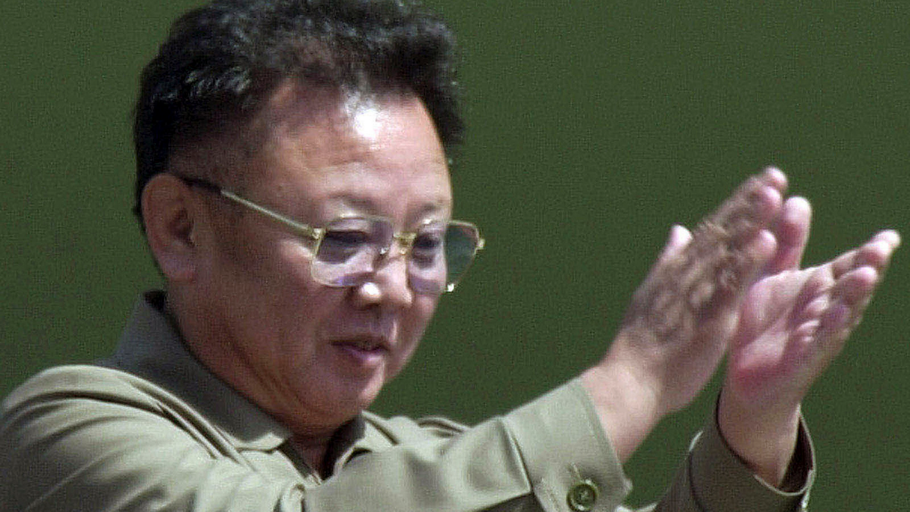 FILE - In this April 25, 2002, file photo, then North Korean leader Kim Jong Il claps from the balcony as soldiers salute him during a military parade, celebrating the foundation of the armed forces in Pyongyang, North Korea. North Koreans are marking the anniversary of the death of leader Kim Jong Il seven years ago with visits to statues and vows of loyalty to his son, Kim Jong Un. (AP Photo/Katsumi Kasahara, File)