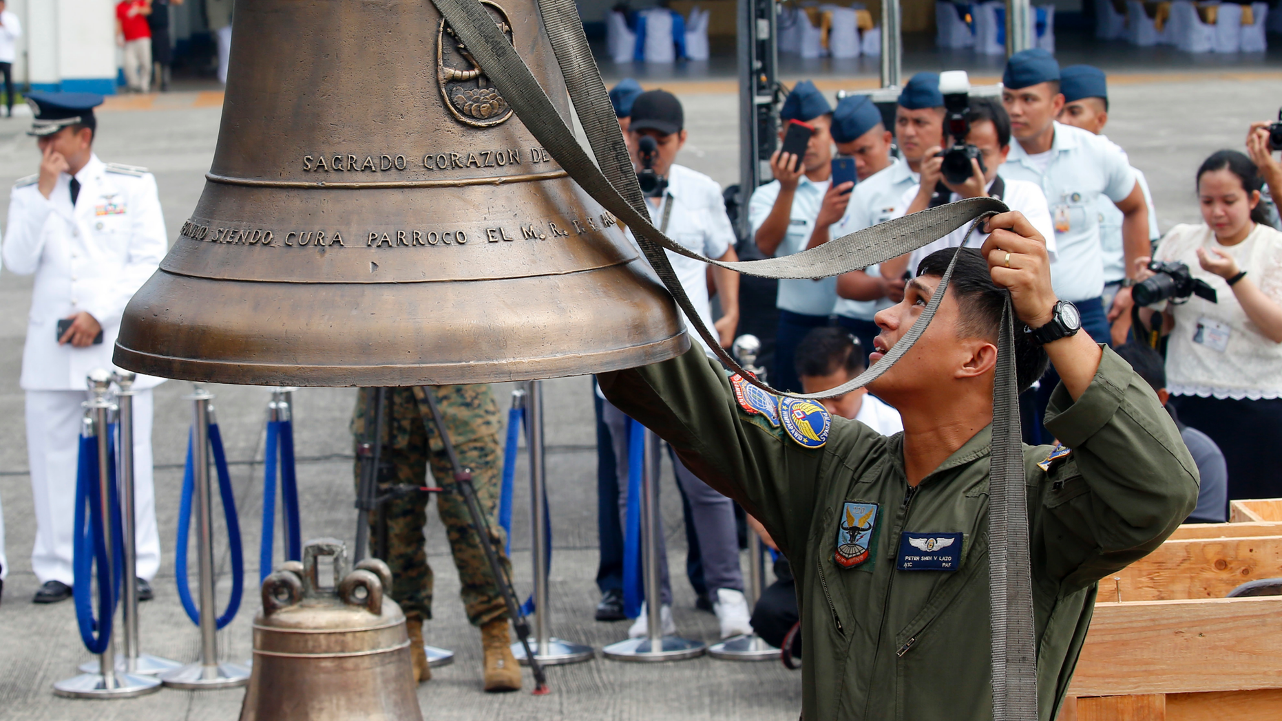 Philippine Air Force personnel unload three church bells seized by American troops as war trophies more than a century ago, as they arrive Tuesday, Dec. 11, 2018 in suburban Pasay city、 southeast of Manila, Philippines. American occupation troops took the bells in 1901 from a Catholic church following an attack by machete-wielding Filipino villagers, who killed 48 U.S. troops in the town of Balangiga on central Samar island in one of the U.S. Army's worst single-battle losses of that era. The bells are revered by Filipinos as symbols of national pride. (AP Photo/Bullit Marquez)