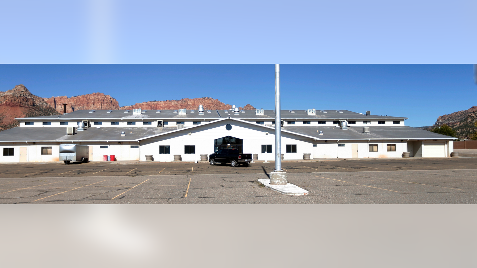 This Oct. 25, 2017, photo shows a meetinghouse in Colorado City, Ariz. A polygamous group known as the Fundamentalist Church of Jesus Christ of Latter Day Saints, or FLDS, is letting go of the sprawling building where its members worshipped, in the latest sign that the sect run by imprisoned leader Warren Jeffs is crumbling and losing control of the community it ruled for a century. (AP Photo/Rick Bowmer)