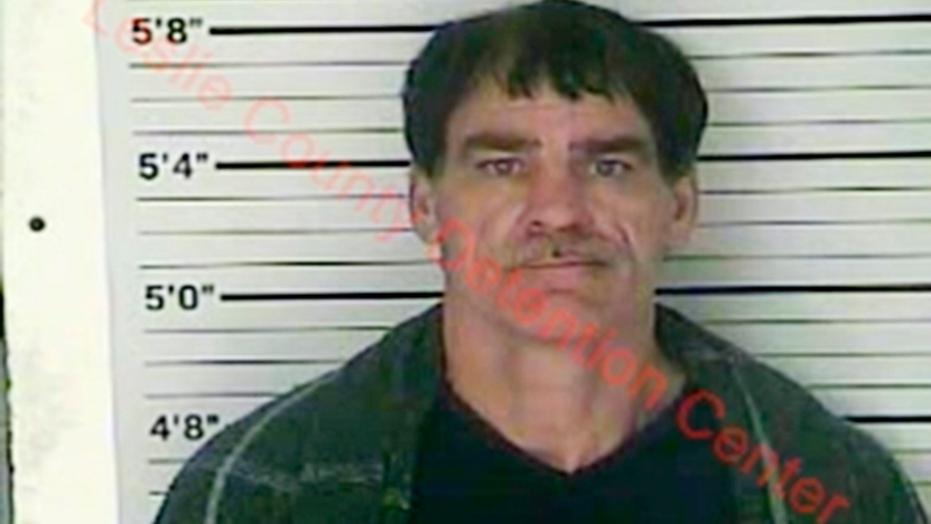 In this Wednesday, Dec. 12, 2018 photo released by the Leslie County (Ky.) Detention Center, Paul Douglas Sizemore is seen in a booking photo. Sizemore, accused of shooting at a state police trooper rushing to the scene of a triple slaying has been charged in the murders of an eastern Kentucky couple and their adult son, police said Thursday. (Leslie County Detention Center via AP)