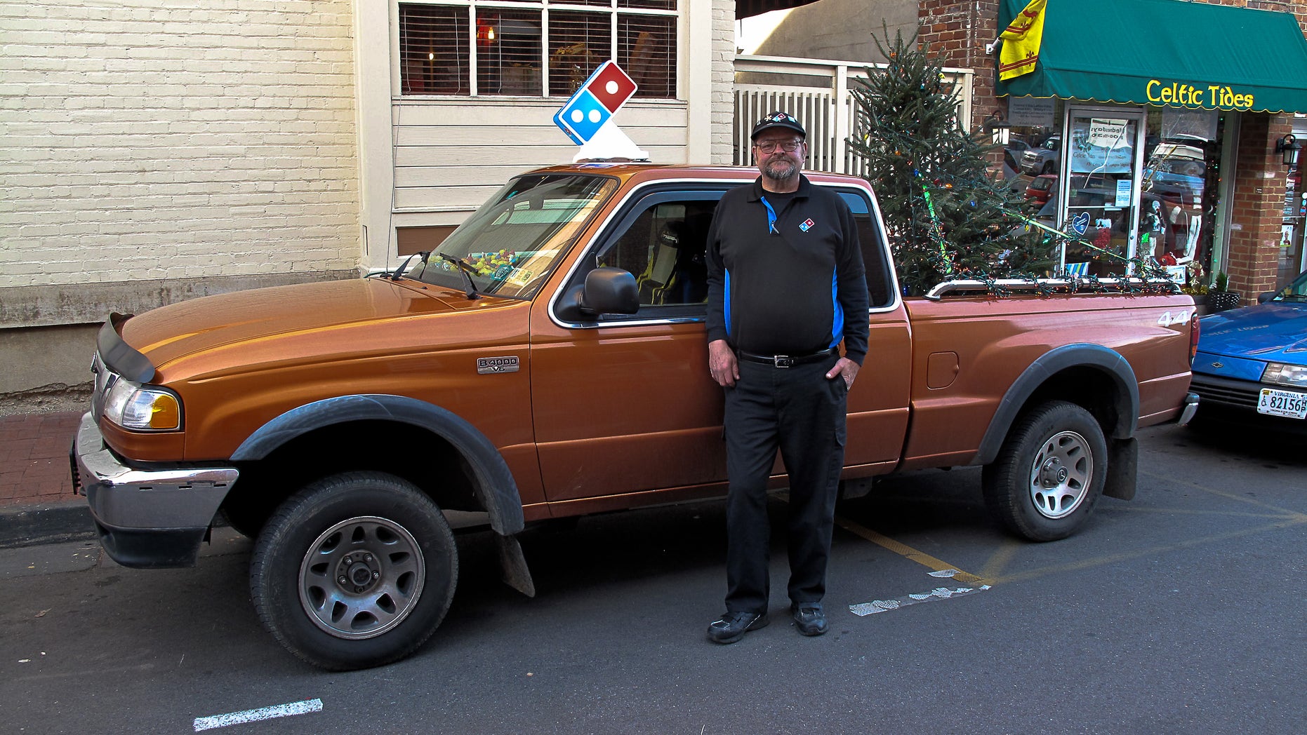 A Domino's delivery driver in Virginia has a fully lit tree in the back of his truck for the holiday season.