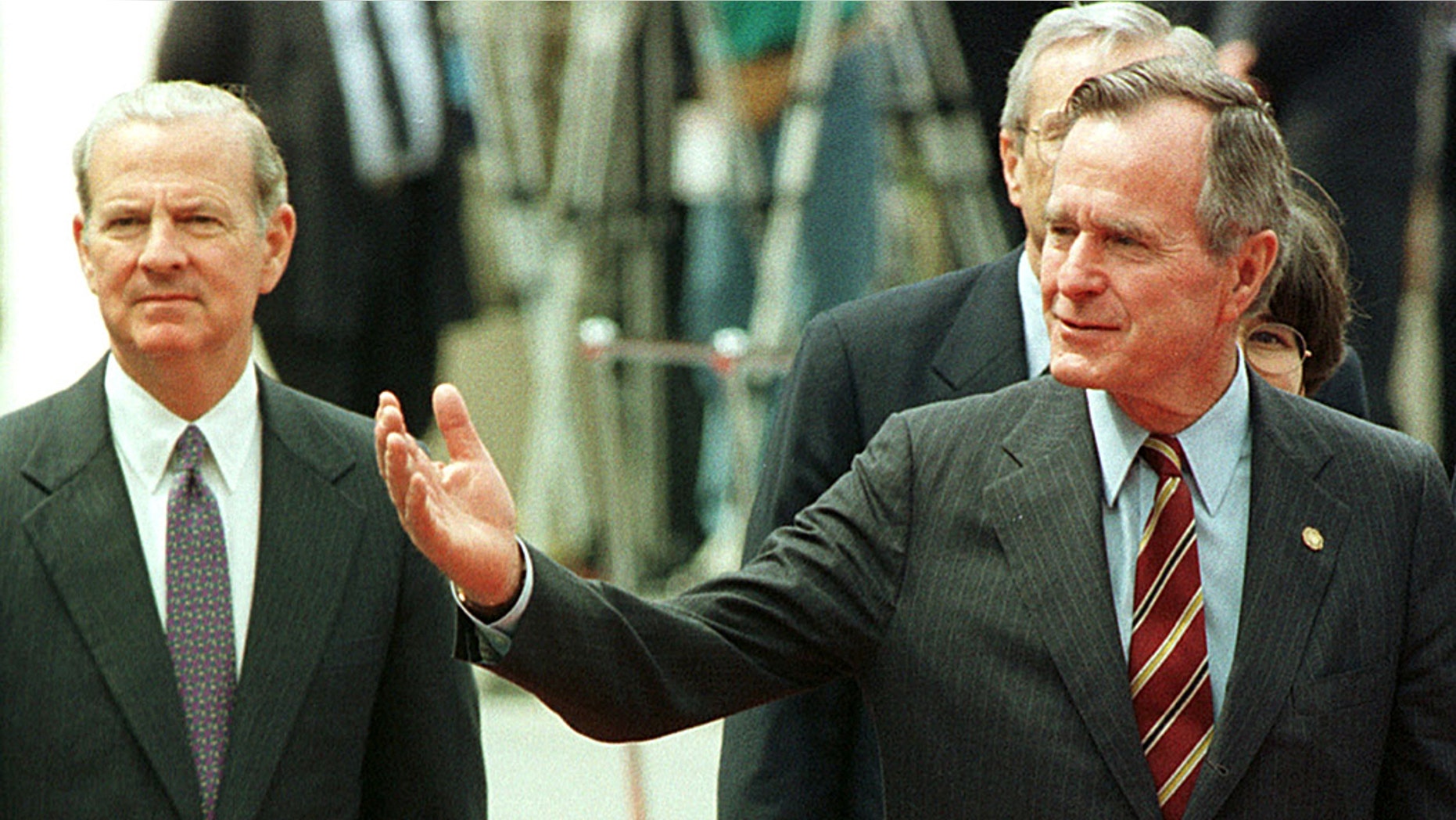 Former U.S. President George H.W. Bush (R) with former U.S. Secretary of State James Baker during a welcome ceremony for the G-7 summit in Munich, June 1992.