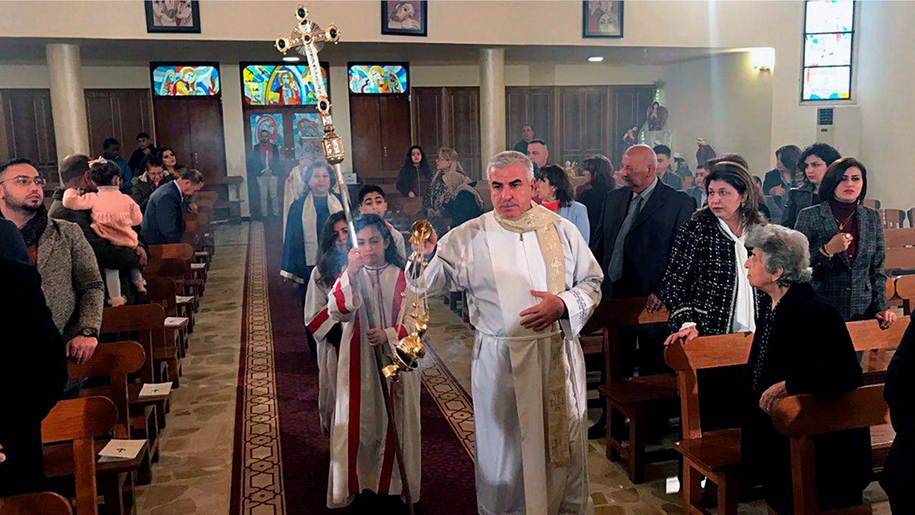 Iraqis attend Christmas Mass at Mar Youssif Chaldean Church, in Baghdad, Iraq, Tuesday, Dec. 25, 2018. Although the number of Christians has dropped in Iraq, Christmas, a national holiday, is very popular in the capital. (AP Photo/Ali Abdul Hassan)