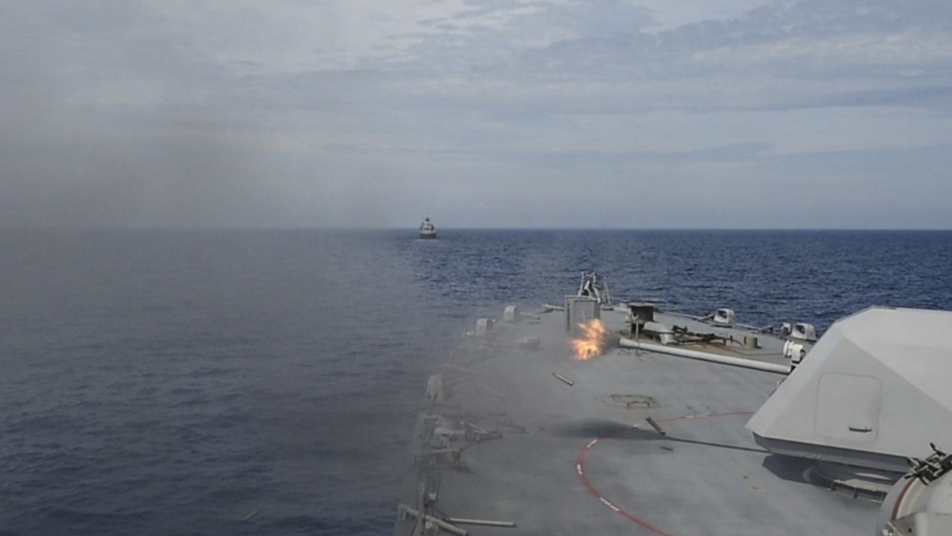 File photo - The littoral combat ship USS Fort Worth (LCS 3) fires at a target during a gun exercise as part of Cooperation Afloat Readiness and Training (CARAT) Malaysia 2015. (U.S. Navy photo by Mass Communication Specialist 2nd Class Joe Bishop/Released)