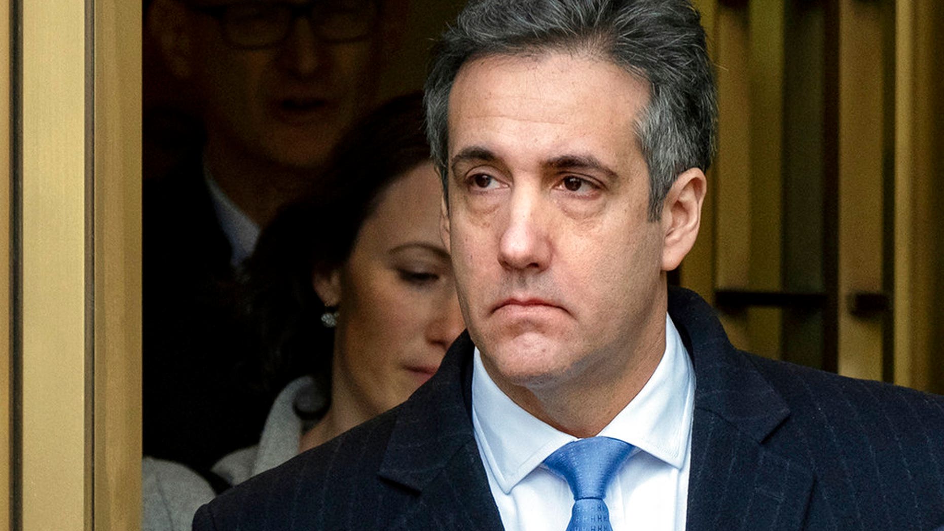 Michael Cohen, President Donald Trump's former lawyer, leaves federal court after his sentencing in New York, Wednesday, Dec. 12, 2018. Cohen was sentenced Wednesday to three years in prison for an array of crimes that included arranging the payment of hush money to two women that he says was done at the direction of Trump. (AP Photo/Craig Ruttle)