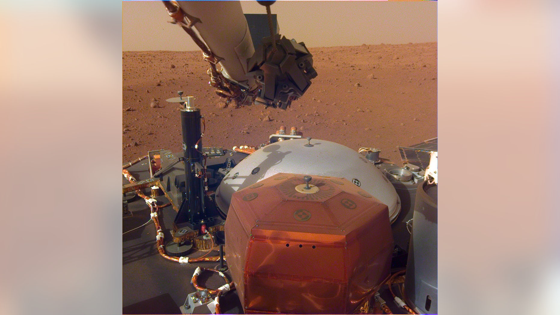 This image from InSight's robotic-arm mounted Instrument Deployment Camera shows the instruments on the spacecraft's deck, with the Martian surface of Elysium Planitia in the background. (Credit: NASA/JPL-Caltech)
