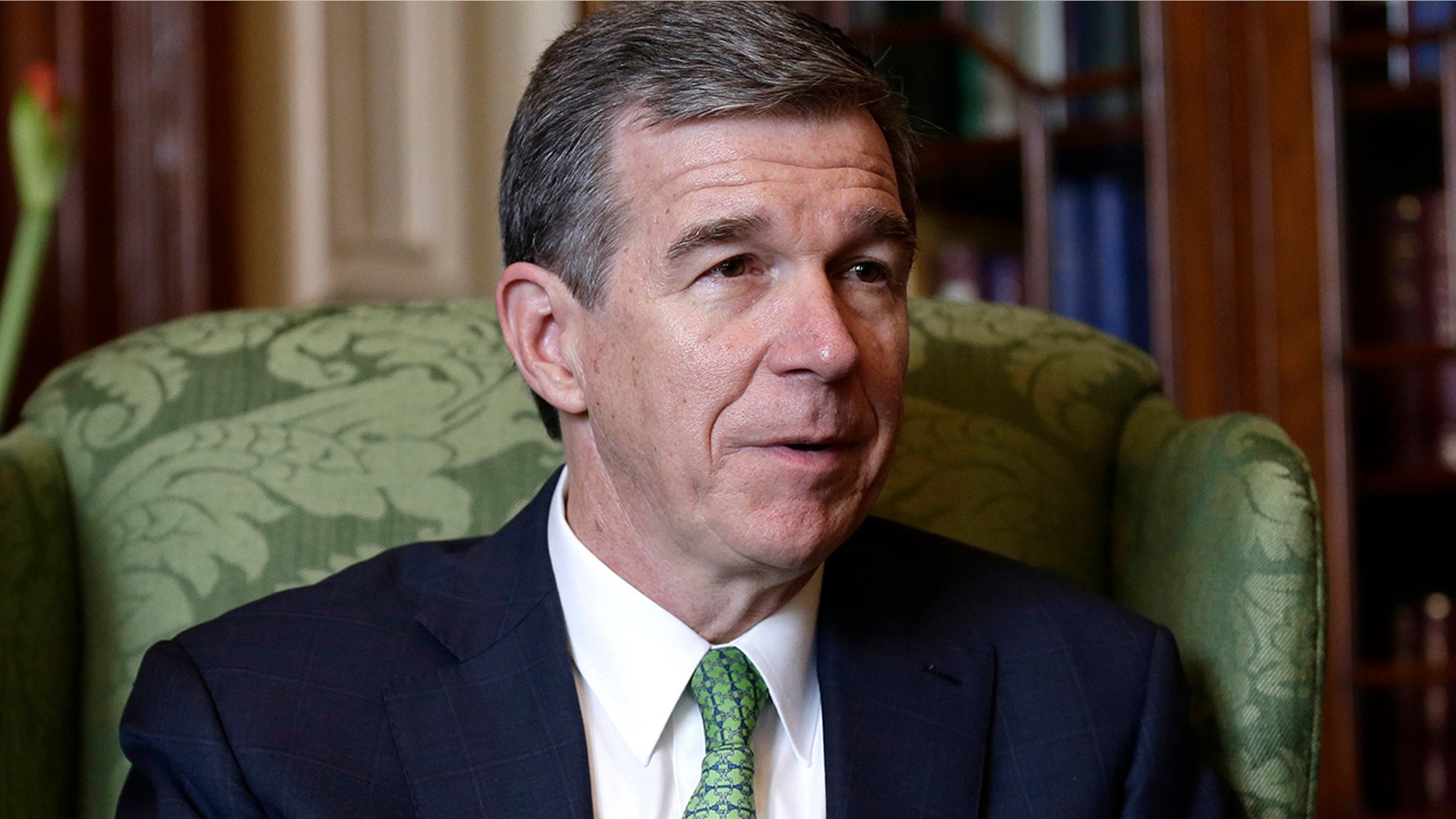 North Carolina Gov. Roy Cooper's veto of a new voter ID bill was overridden by the state's Republican lawmakers on Wednesday. (AP Photo/Gerry Broome)