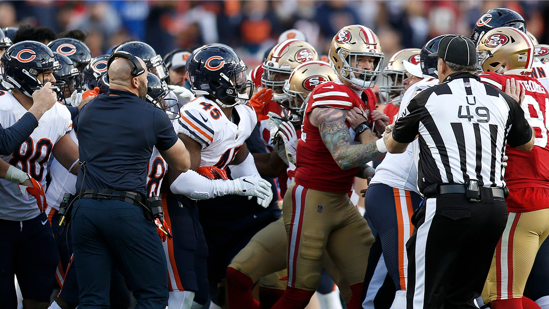 Coaches and officials try to separate Chicago Bears and San Francisco 49ers players during the second half of an NFL football game in Santa Clara, Calif., Sunday, Dec. 23, 2018.