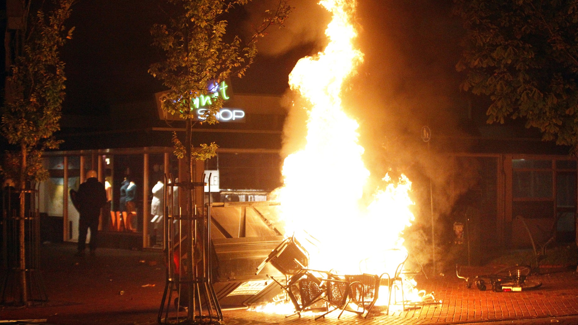 File photo - Chairs burn in the northern Dutch town of Haren late on Sept. 21, 2012 as riot police went into action to contain thousands of party-goers who turned up after a teenager's birthday invite on Facebook went viral. (CATRINUS VAN DER VEEN/AFP/GettyImages)