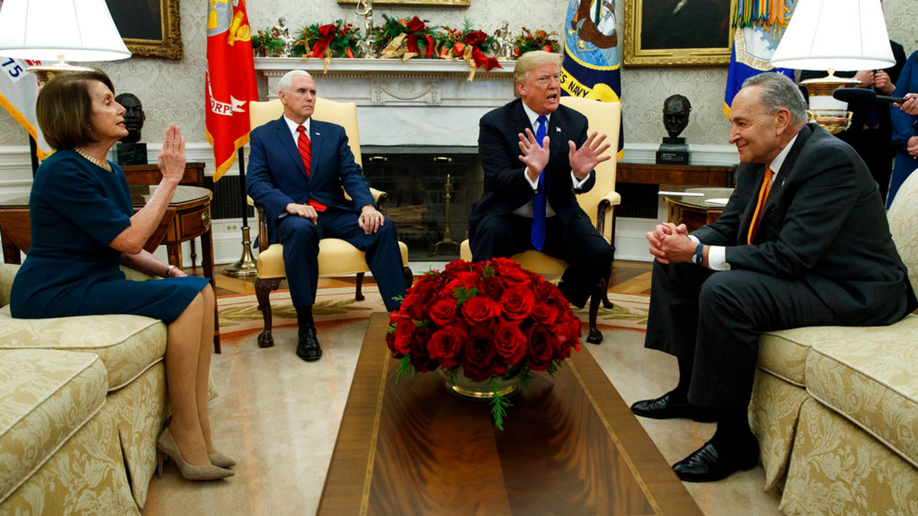 House Minority Leader Rep. Nancy Pelosi, D-Calif., Vice President Mike Pence, President Donald Trump, and Senate Minority Leader Chuck Schumer, D-N.Y., argue during a meeting in the Oval Office of the White House, Tuesday, Dec. 11, 2018, in Washington. (AP Photo/Evan Vucci)