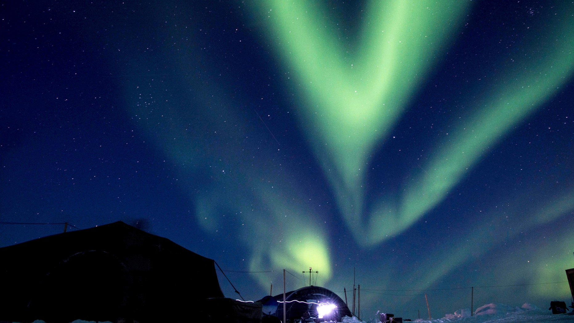 FILE - In this March 9, 2018, file photo provided by the U.S. Navy, the aurora borealis displays above Ice Camp Skate in the Beaufort Sea during Ice Exercise (ICEX) 2018. Scientists are seeing surprising melting in Earth's polar regions at times they don't expect, like winter, and in places they don't expect, like eastern Antarctica. (MC 2nd Class Micheal H. Lee/U.S. Navy via AP, File)
