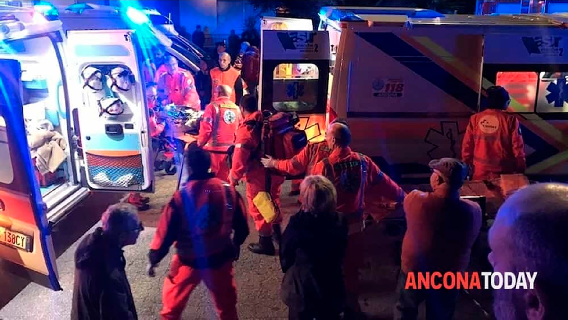Rescuers assist injured people outside a nightclub in Corinaldo, central Italy, early Saturday, Dec. 8, 2018. (Stefano Pagliarini/Ancona Today via AP)
