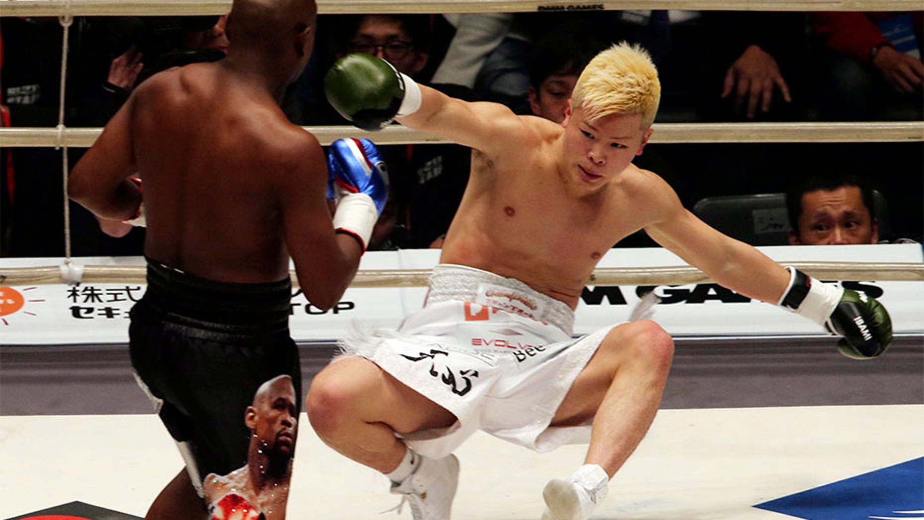 Japanese kickboxer Tenshin Nasukawa lies on the mat after being knocked out by Floyd Mayweather Jr. during first round of their three-round exhibition match on New Year's Eve, at Saitama Super Arena in Saitama, north of Tokyo.