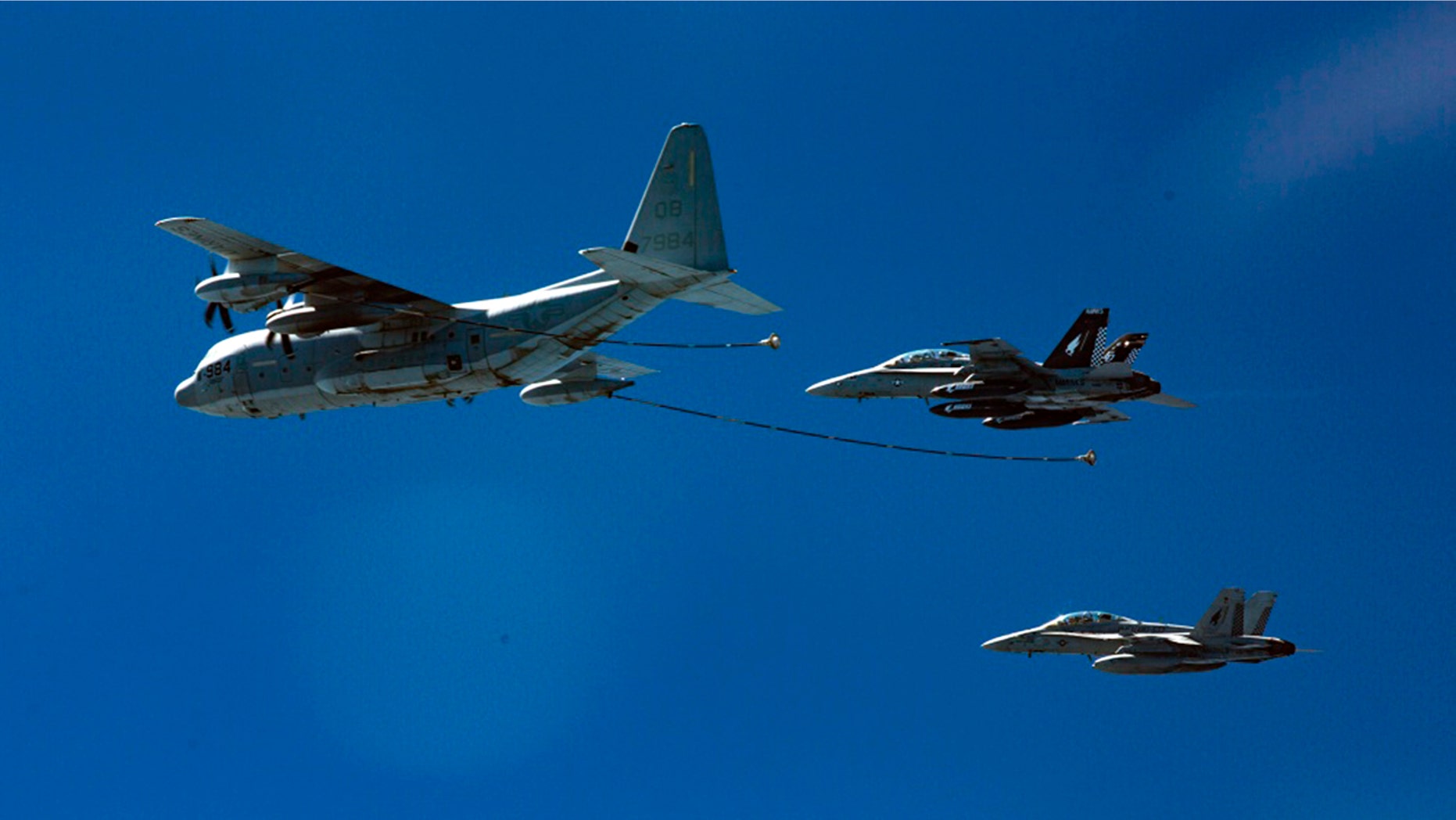 Two F/A-18D Hornets with Marine All-Weather Fighter Attack Squadron 533 approach a KC-130J with Marine Aerial Refueler Transport Squadron 352 during a Special Purpose Marine Air-Ground Task Force - Crisis Response - Central Command aerial refueling exercise in undisclosed location. (Cpl. Trever Statz/U.S. Marine Corps via AP)