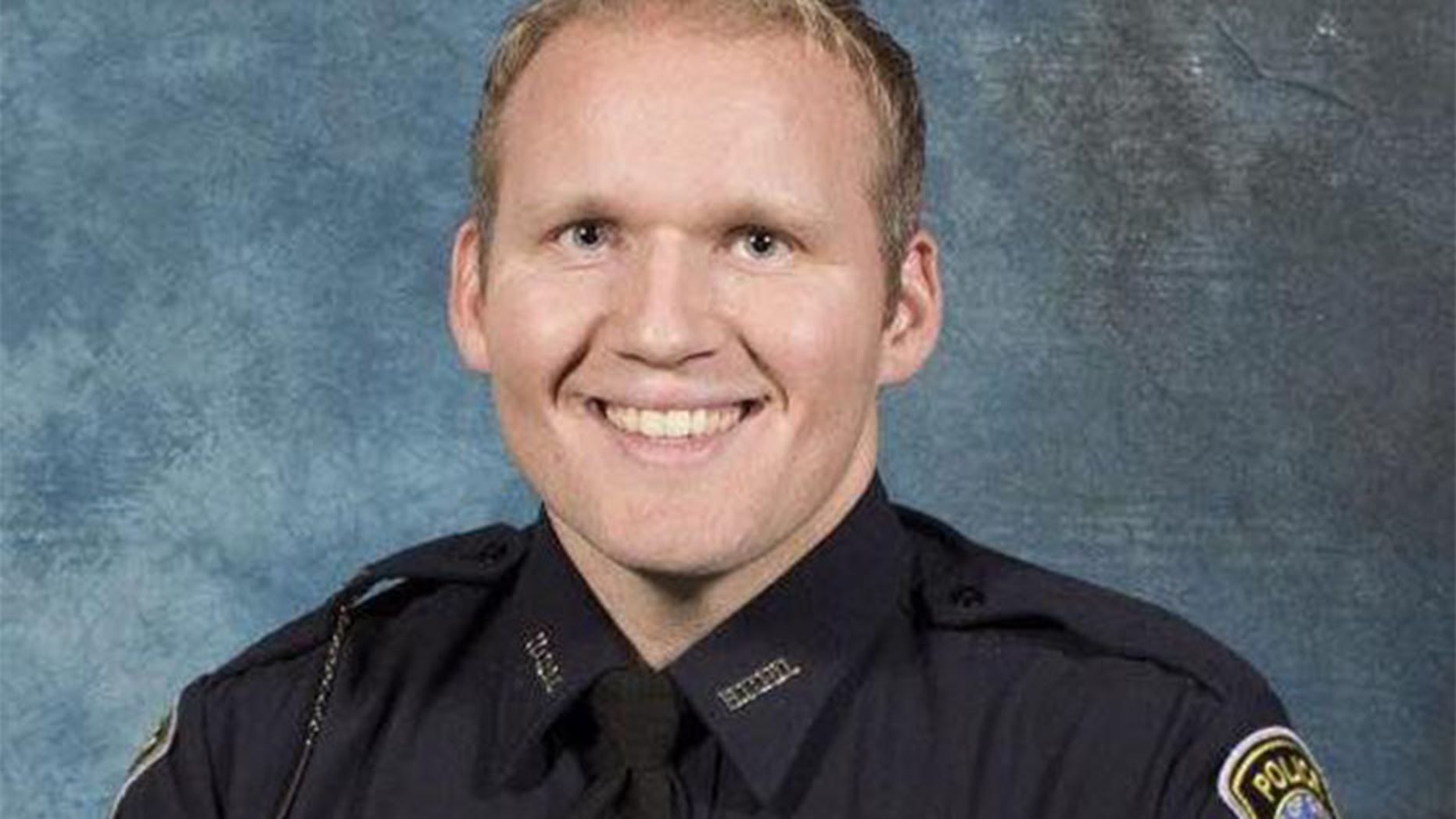 Henry County Police Officer Michael Smith died Friday from injuries suffered during a shooting on Dec. 6.