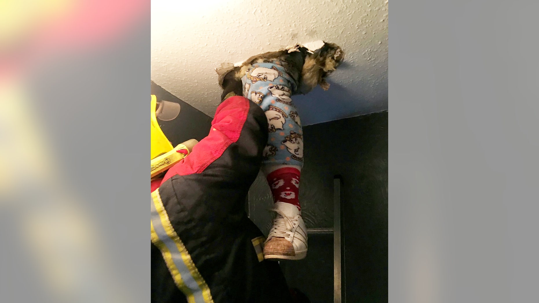 Stacielea Doran got stuck between floors with just the legs of her "Beauty and the Beast" onesie dangling into the room below.
