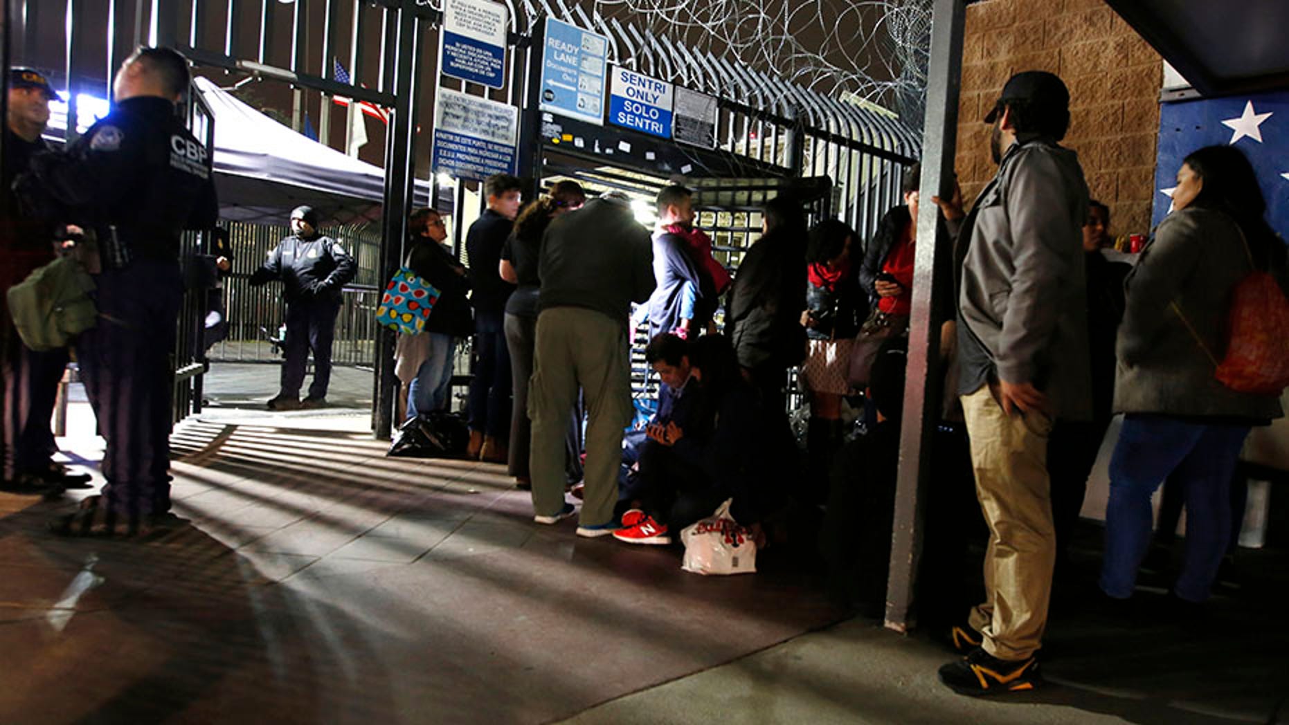 Activists for migrant rights surround a group of Honduran asylum seekers camped on U.S. soil at San Diego's Otay Mesa port of entry, seen from Tijuana, Mexico.
