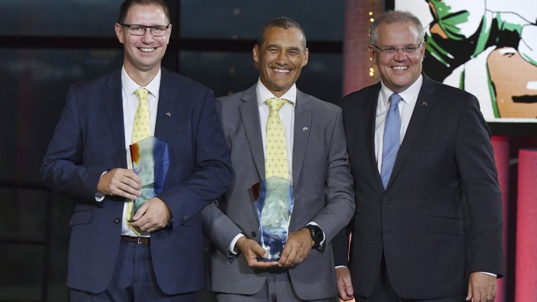 Prime Minister Scott Morrison, right, stands with winners 2019 Australians of the Year; Dr. Richard Harris, left, and Craig Challen at the 2019 Australian of the Year Awards in Canberra, Australia, Friday, Jan. 25, 2019.