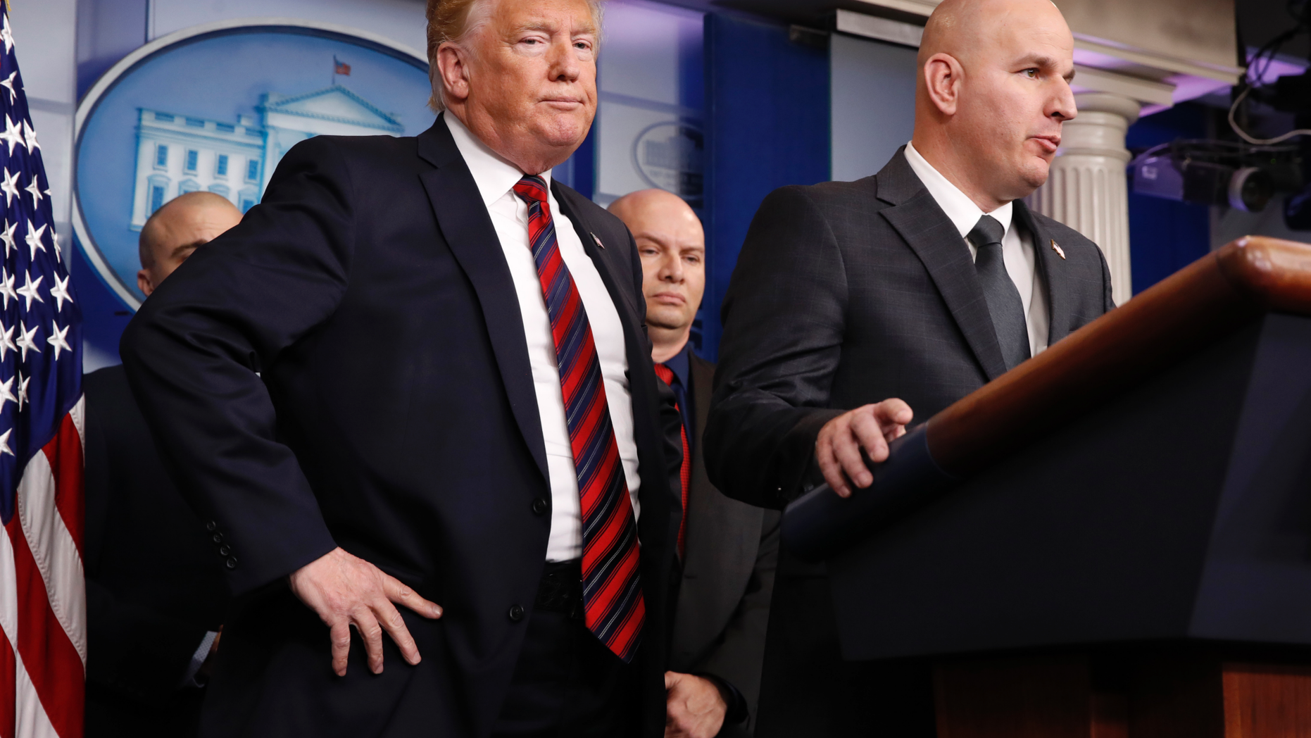 President Donald Trump, left, listens as Brandon Judd, president of the National Border Patrol Council, talks about border security, Thursday Jan. 3, 2019, after making a surprise visit to the press briefing room of the White House in Washington. (AP Photo/Jacquelyn Martin)
