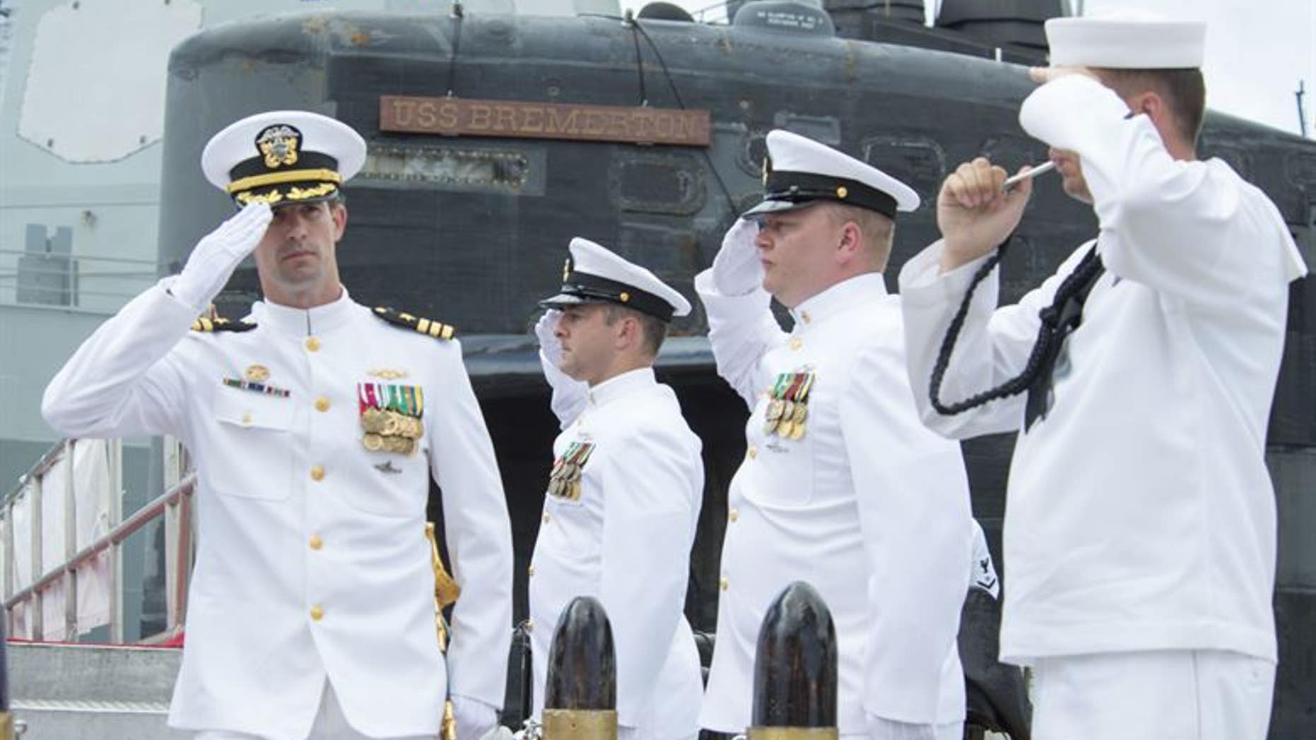 Cmdr. Travis W. Zettel (left), commanding officer of the Los Angeles-class fast-attack submarine USS Bremerton (SSN 698), salutes sideboys during a change of command ceremony on Joint Base Pearl Harbor-Hickam.