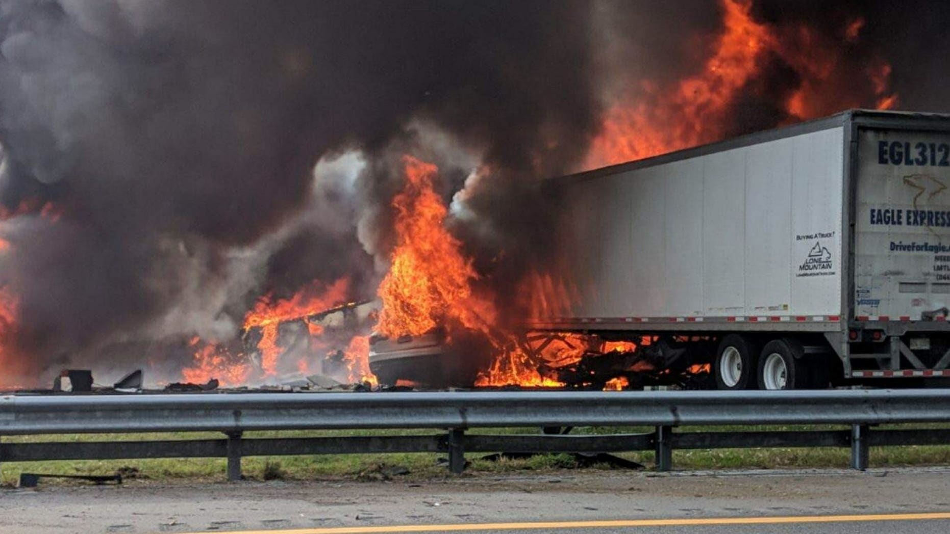 Flames engulf vehicles after a fiery crash along Interstate 75, Thursday, Jan. 3, 2019, about a mile south of Alachua, near Gainesville, Fla.