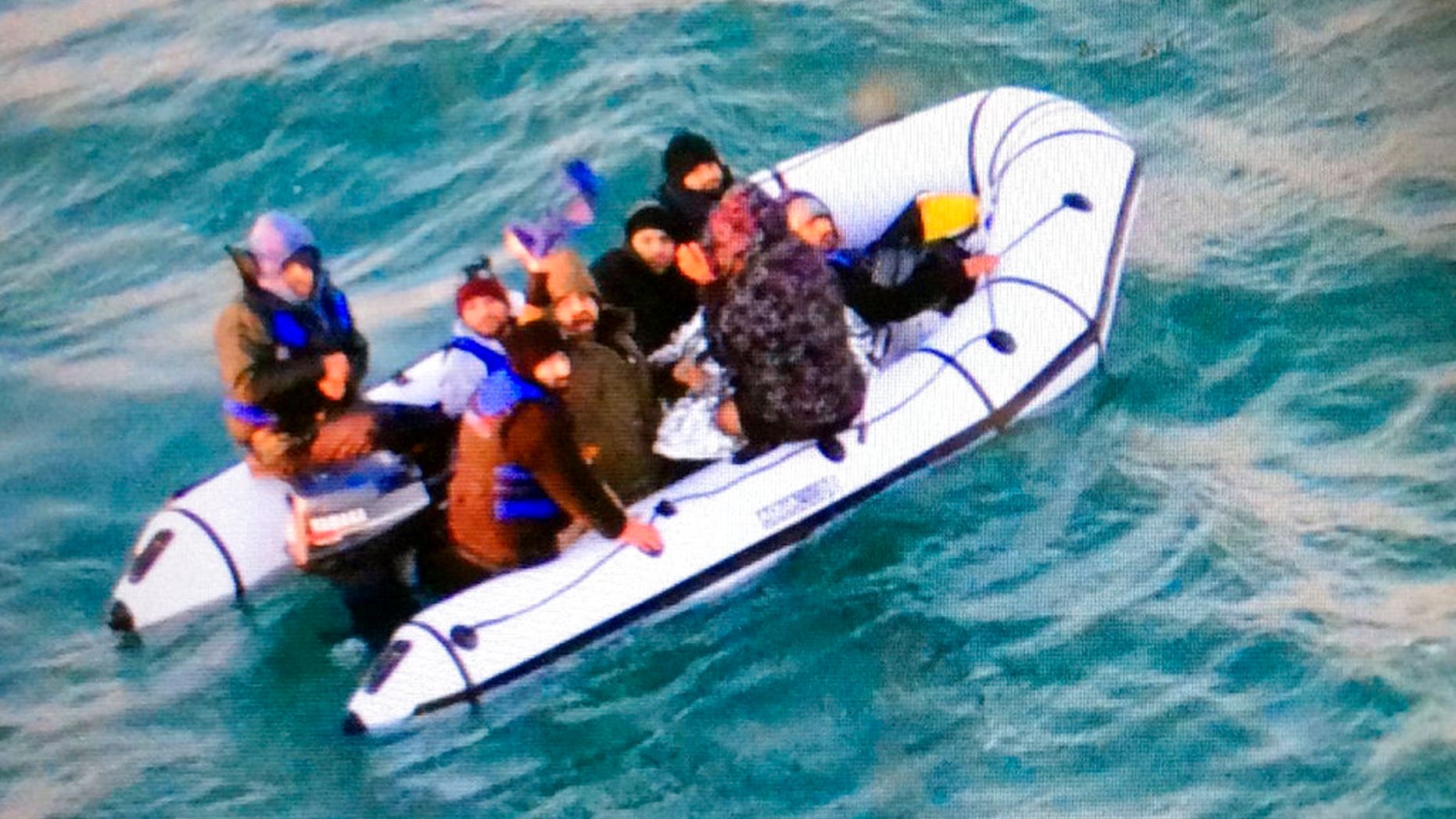 This image provided by the Marine Nationale (French Navy) shows migrants aboard a rubber boat after being intercepted by French authorities, off the port of Calais, northern France, Tuesday, Dec. 25, 2018. (Marine Nationale via AP)