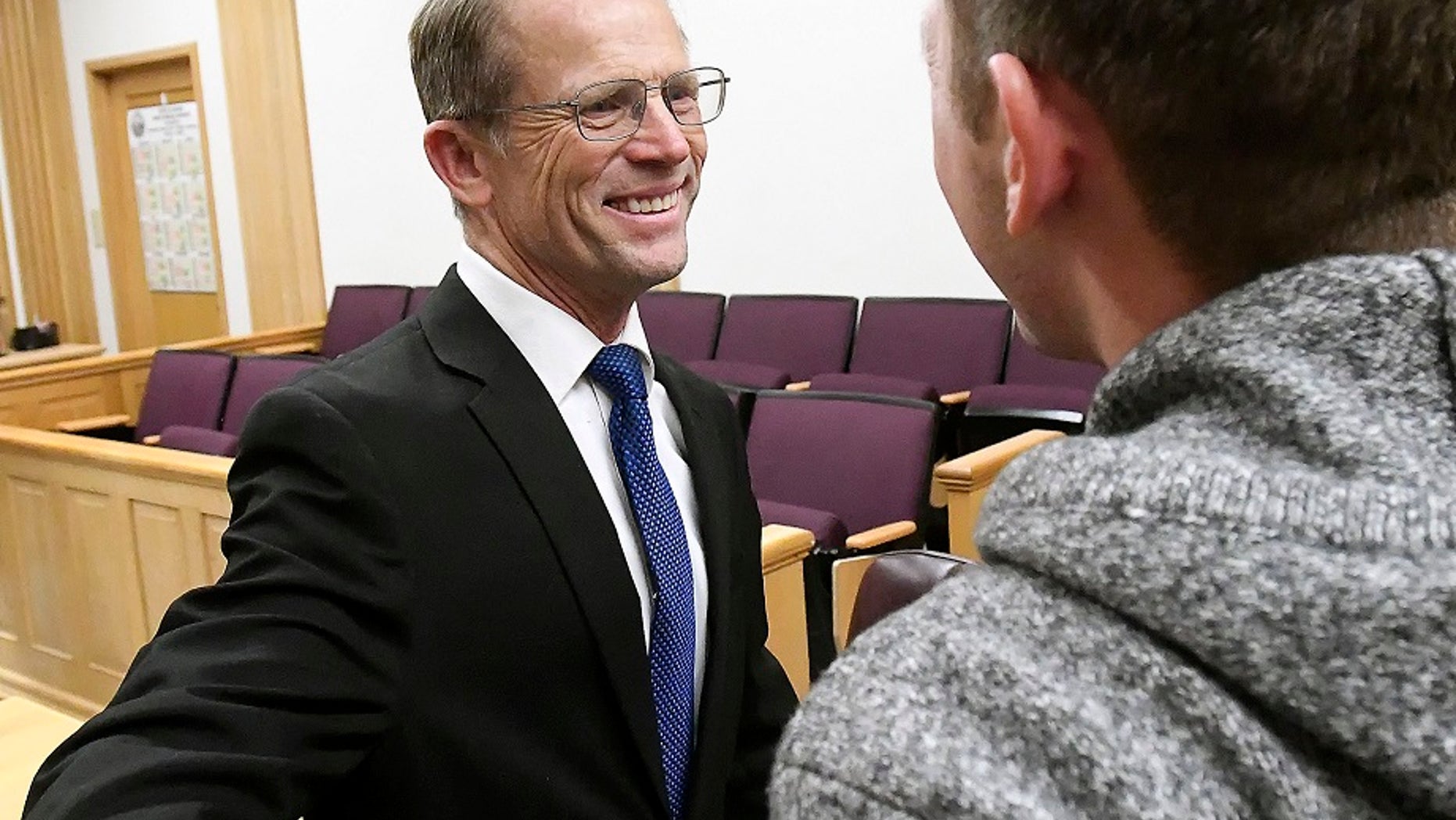 Robert Crosland smiles at son Mario Crosland after Robert was found not guilty of misdemeanor animal cruelty, Friday, Jan. 4, 2019, in Preston, Idaho. (Associated Press)