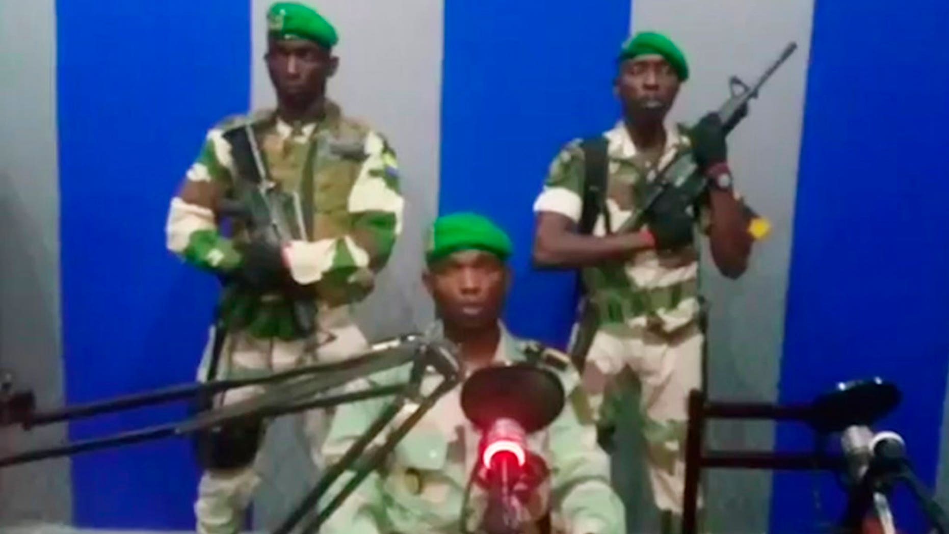 A soldier who identified himself as Lt. Obiang Ondo Kelly, commander of the Republican Guard, reads a statement on state television broadcast from Libreville, saying the military has seized control of the government. (