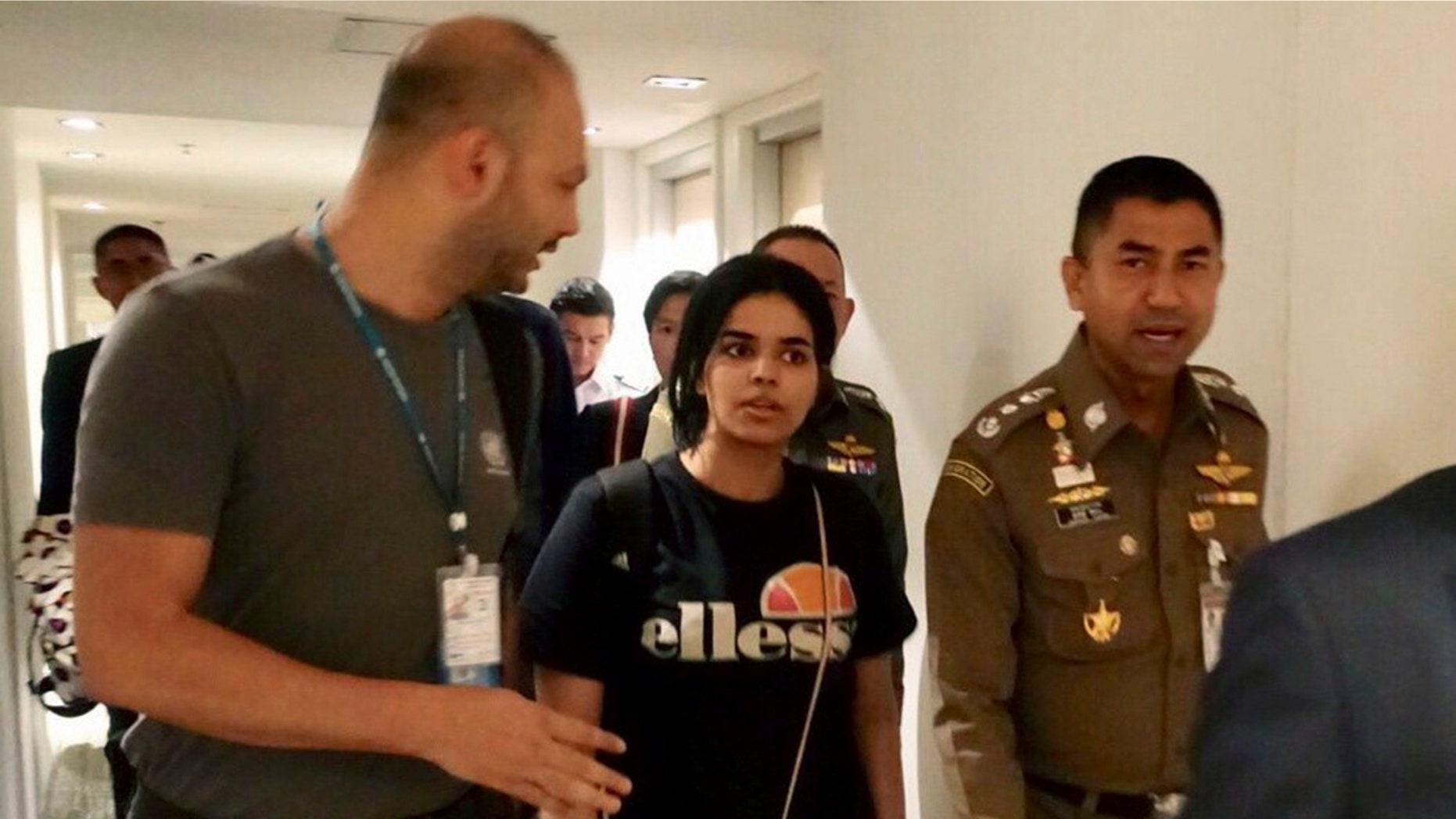 Saudi woman Rahaf Mohammed Alqunun moments before leaving the Suvarnabhumi Airport in Bangkok Monday. The 18-year-old began posting on Twitter late Saturday after her passport was taken away when she arrived on a flight from Kuwait. (Immigration police via AP)