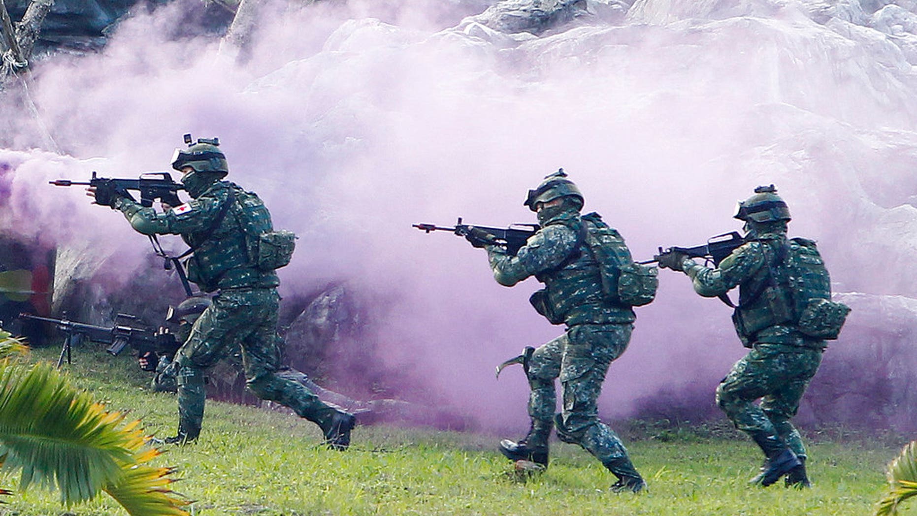 FILE: Soldiers from Taiwan's special forces move through colored smoke during a military exercise in Taipei, Taiwan.