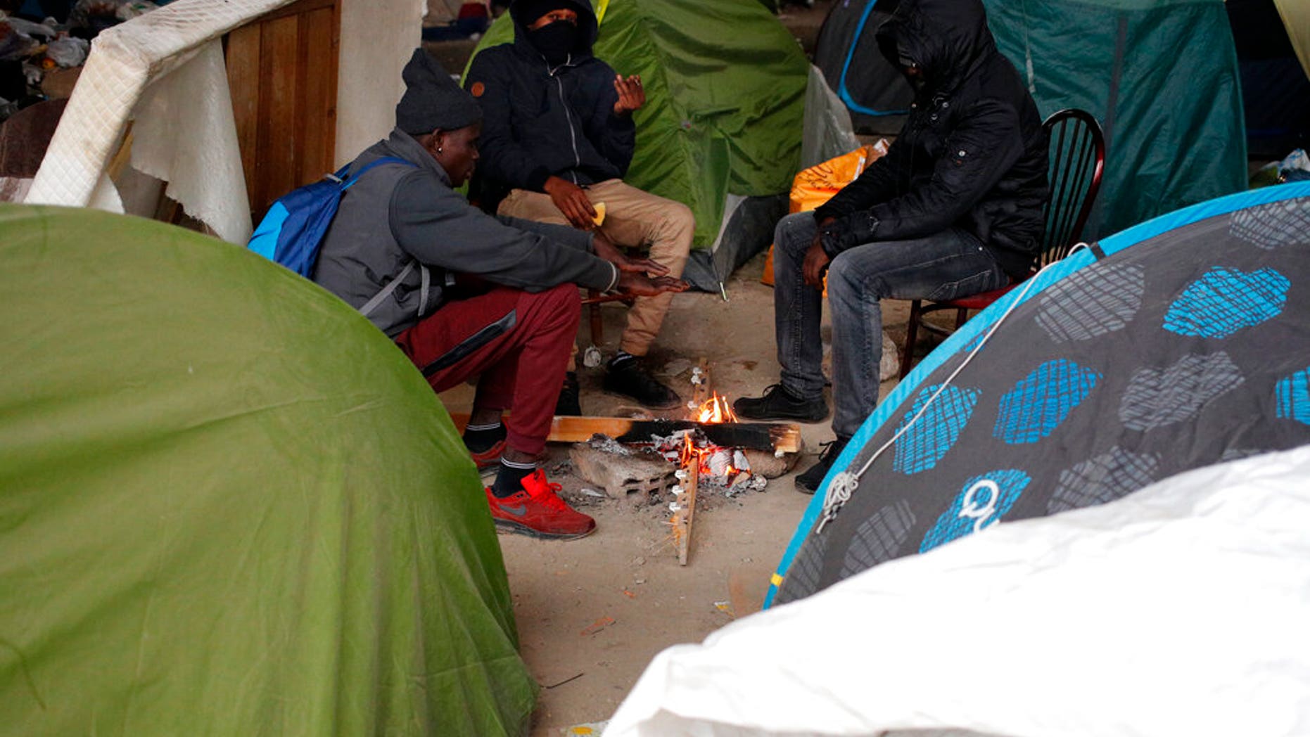 Migrants mainly from Sudan, and Chad, Africa, gather in a makeshift camp along side of the Porte de la Villette ring bridge in Paris, Friday, Jan. 11, 2019.