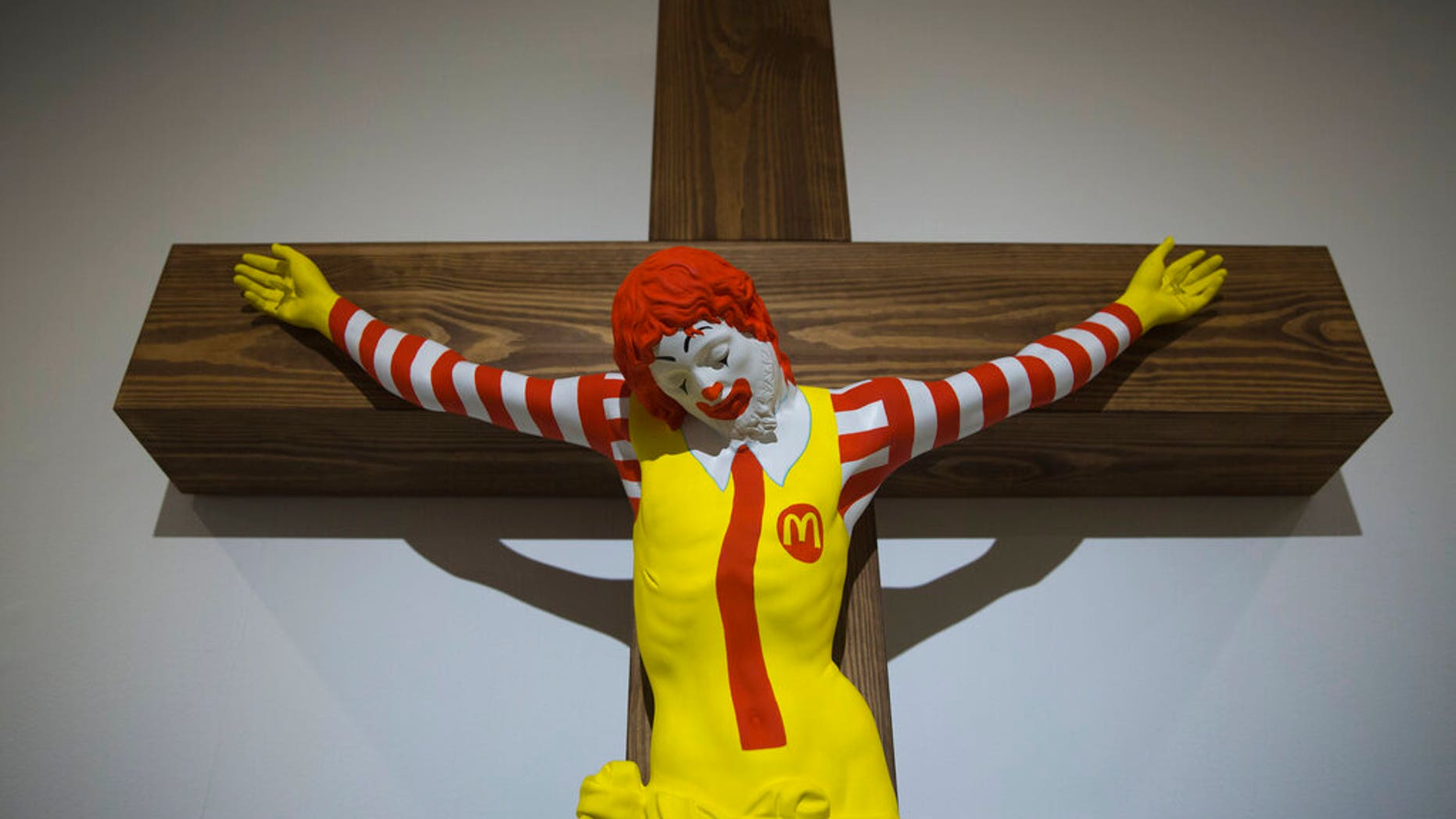 An artwork called "McJesus," which was sculpted by Finnish artist Jani Leinonen and depicts a crucified Ronald McDonald, is seen on display as part of the Haifa museum's "Sacred Goods" exhibit, in Haifa, Israel, Monday, Jan. 14, 2019. Hundreds of Christians calling for the sculpture's removal protested at the museum last week. (AP Photo/Oded Balilty)