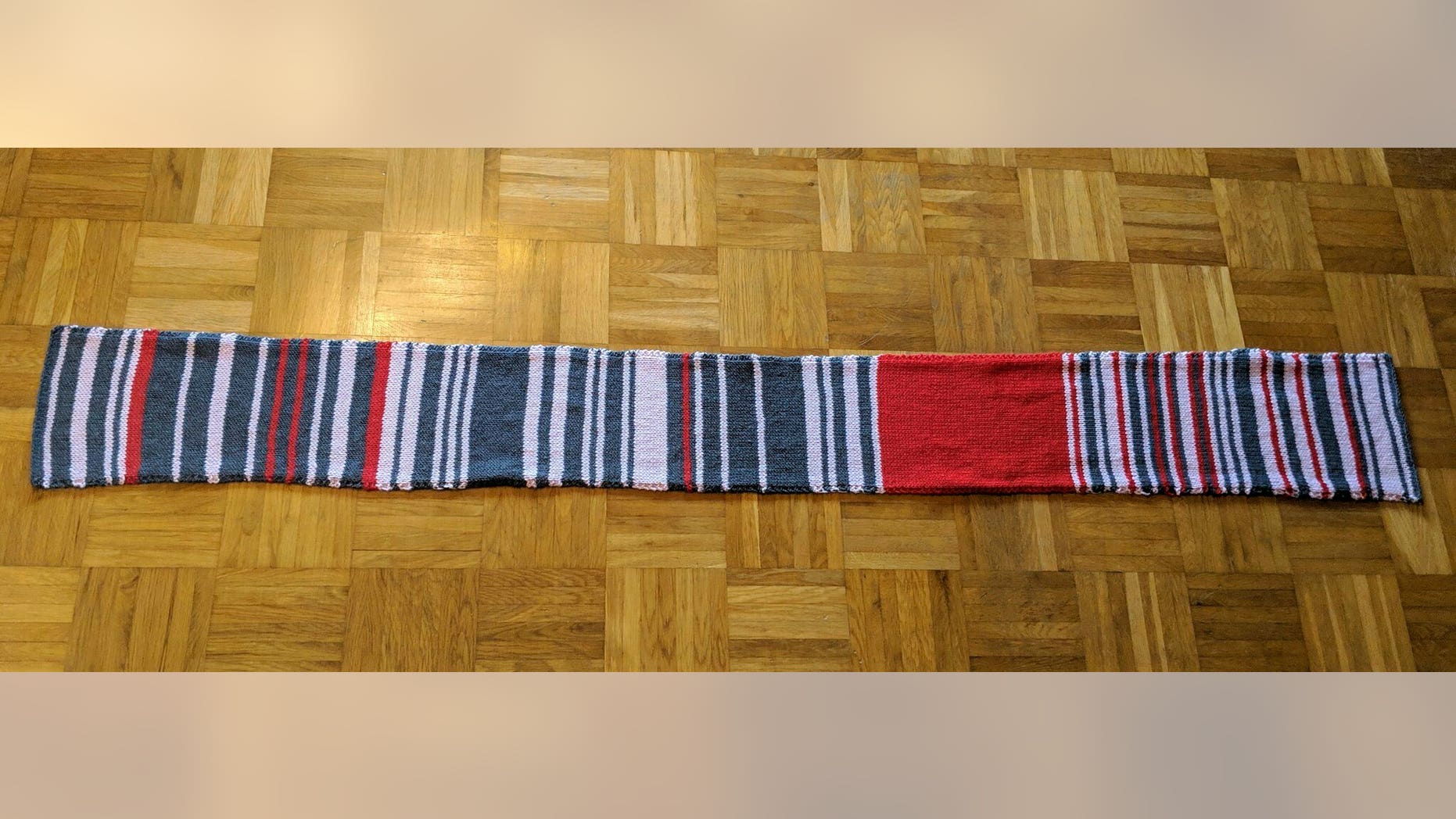 This undated photo made available Thursday Jan. 17, 2019, shows the so called 'delay scarf' which a Munich commuter has knitted with each colour reflecting the amount of time her journey with Deutsche Bahn train service had been delayed. The hand-made scarf sold in an online auction for 7,550 euros (dollars 8,600) to the German Railway Deutsche Bahn. The money is being donated to a charity for the homeless. (Sara Weber via AP)