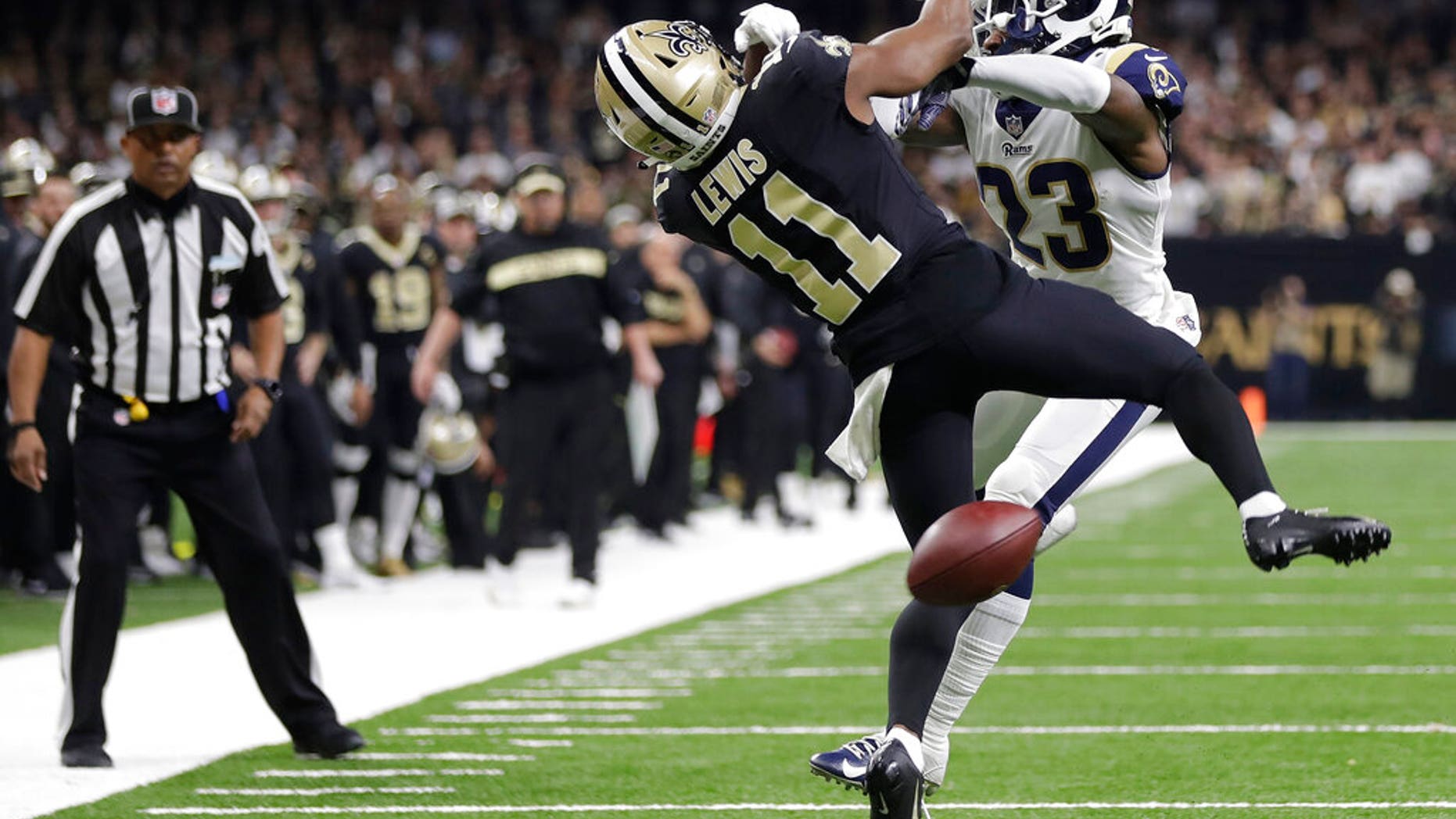 Saxon receiver Tommylee Lewis (11) works for a coach against Los Angeles Rams defender Nickell Robey-Coleman (23) during the second half of the NFL football NFC championship game Sunday.