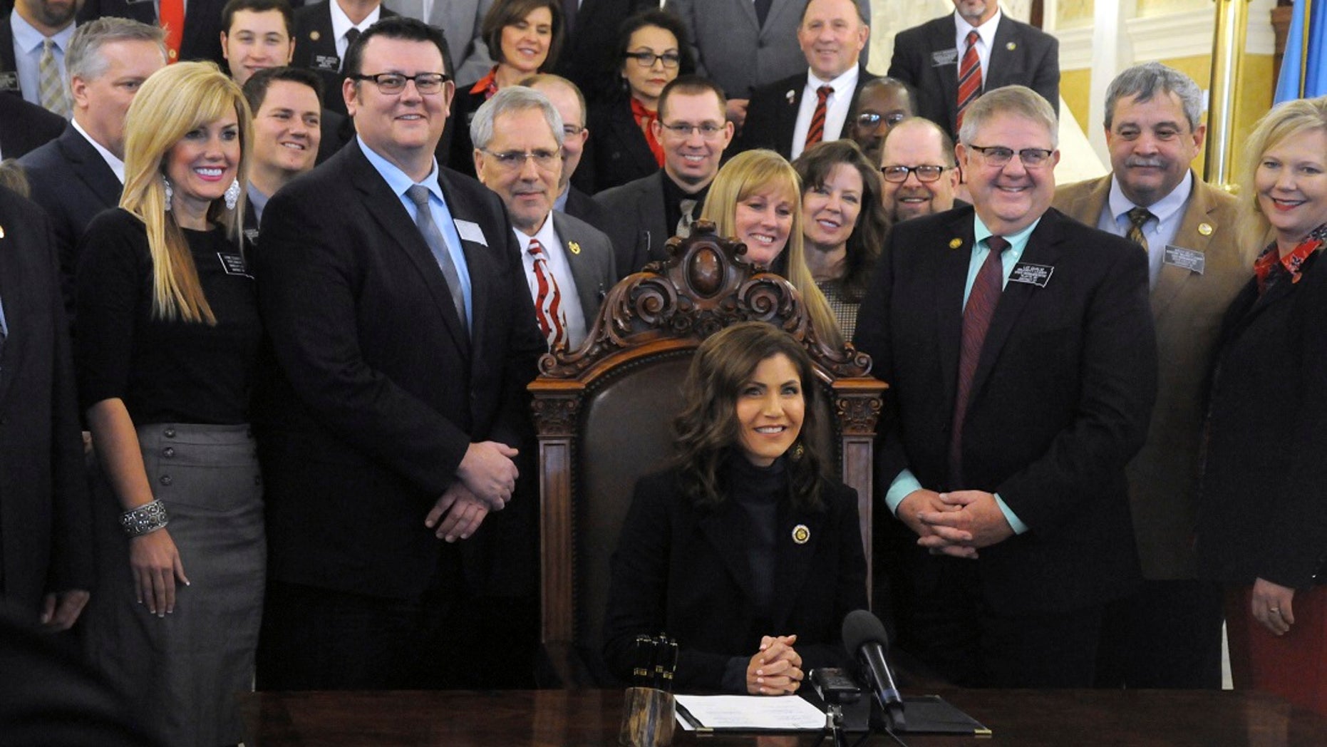 Gov. Kristi Noem smiles after signing her first bill into law at the state Capitol in Pierre, S.D., Thursday, Jan. 31, 2019. The measure allows people to carry concealed pistols without a permit in the state. (Associated Press)