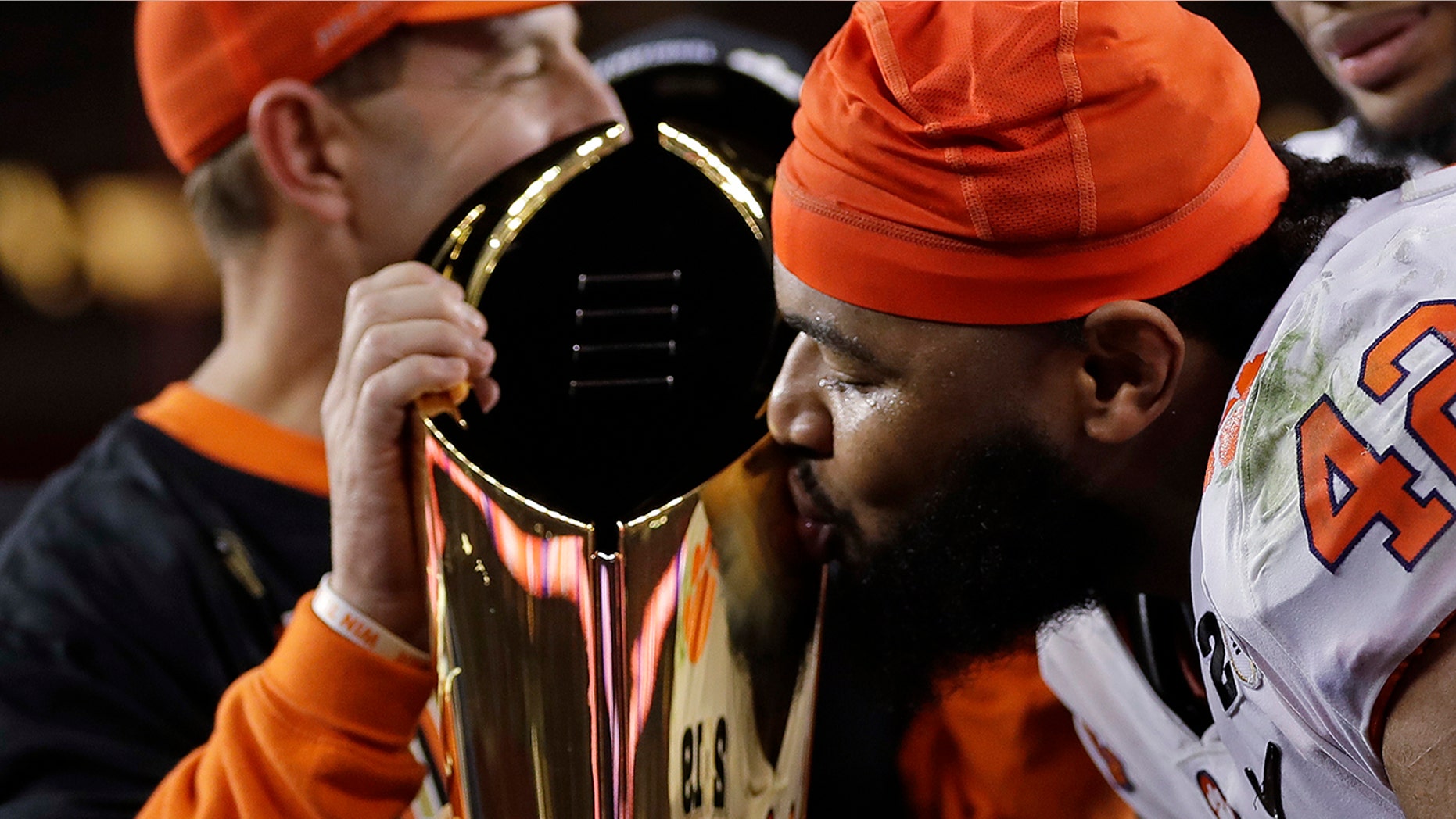 Clemson's Christian Wilkins kisses the trophy after the NCAA college football playoff championship game against Alabama, Monday, Jan. 7, 2019, in Santa Clara, Calif. Clemson beat Alabama 44-16.