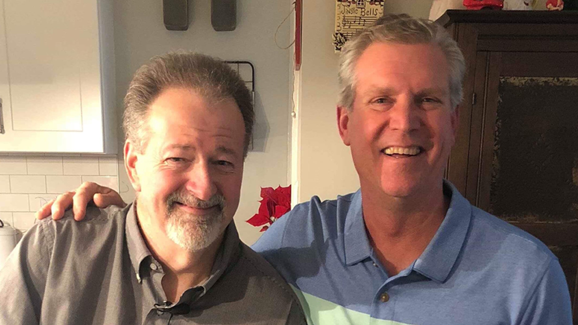 Mike Hodgin, left, considers his mailman, Chris Petersen, right, a hero after he saved his life on Christmas Eve. The two reunited on New Year's Day.