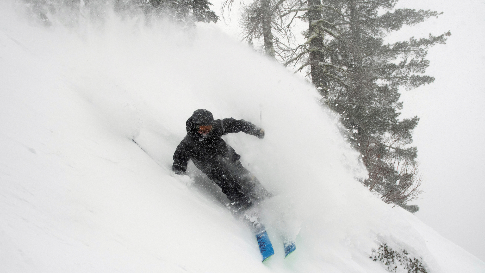 In this photo provided by Blake Kessler, Wesley Kepke skis in Alpine Meadows, Calif., on Sunday, Jan. 6, 2019. A winter storm swept through parts of California, Nevada and Utah, bringing heavy snow to some communities. (Blake Kessler via AP)