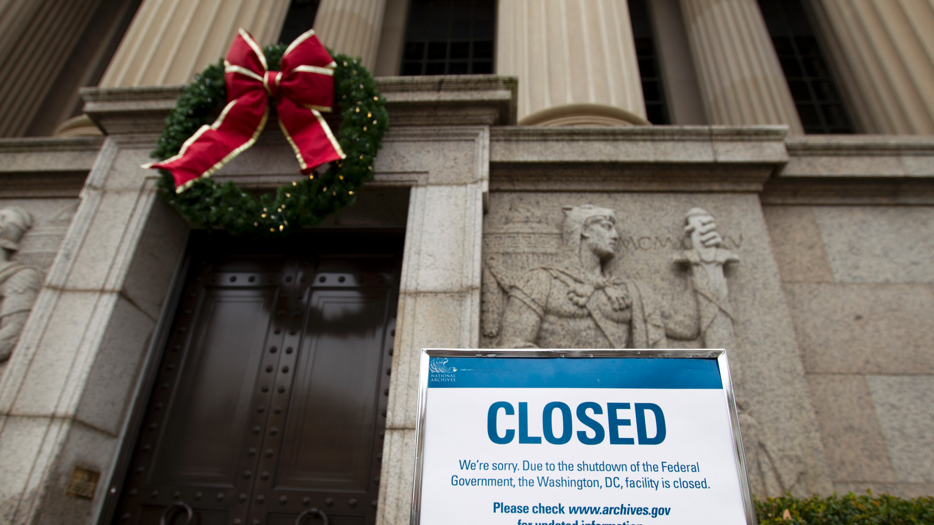 A closed sign is displayed at The National Archives entrance in Washington, Tuesday, Jan. 1, 2019, as a partial government shutdown stretches into its third week. A high-stakes move to reopen the government will be the first big battle between Nancy Pelosi and President Donald Trump as Democrats come into control of the House.  (AP Photo/Jose Luis Magana)