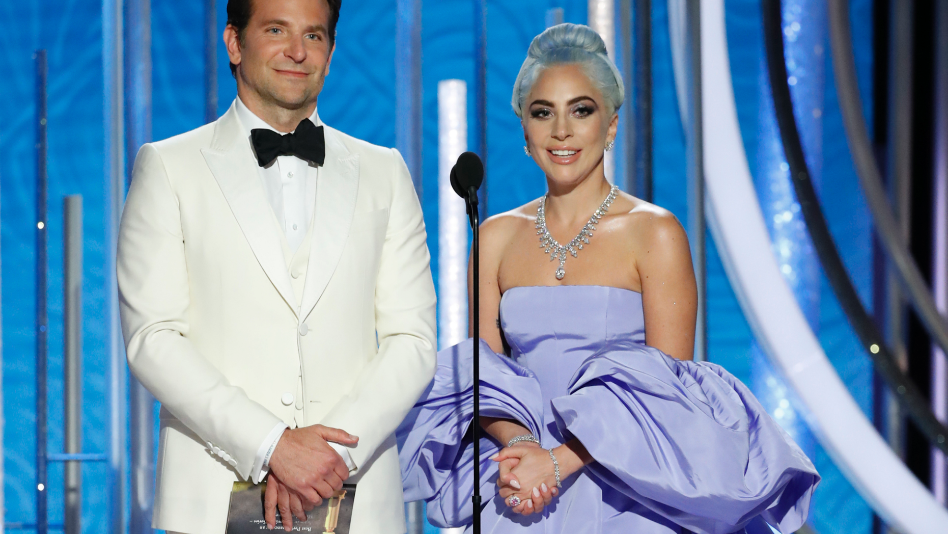 This image released by NBC shows Bradley Cooper, left, and Lady Gaga presenting the award for best actor in a TV comedy series at the 76th Annual Golden Globe Awards at the Beverly Hilton Hotel on Sunday, Jan. 6, 2019, in Beverly Hills, Calif.