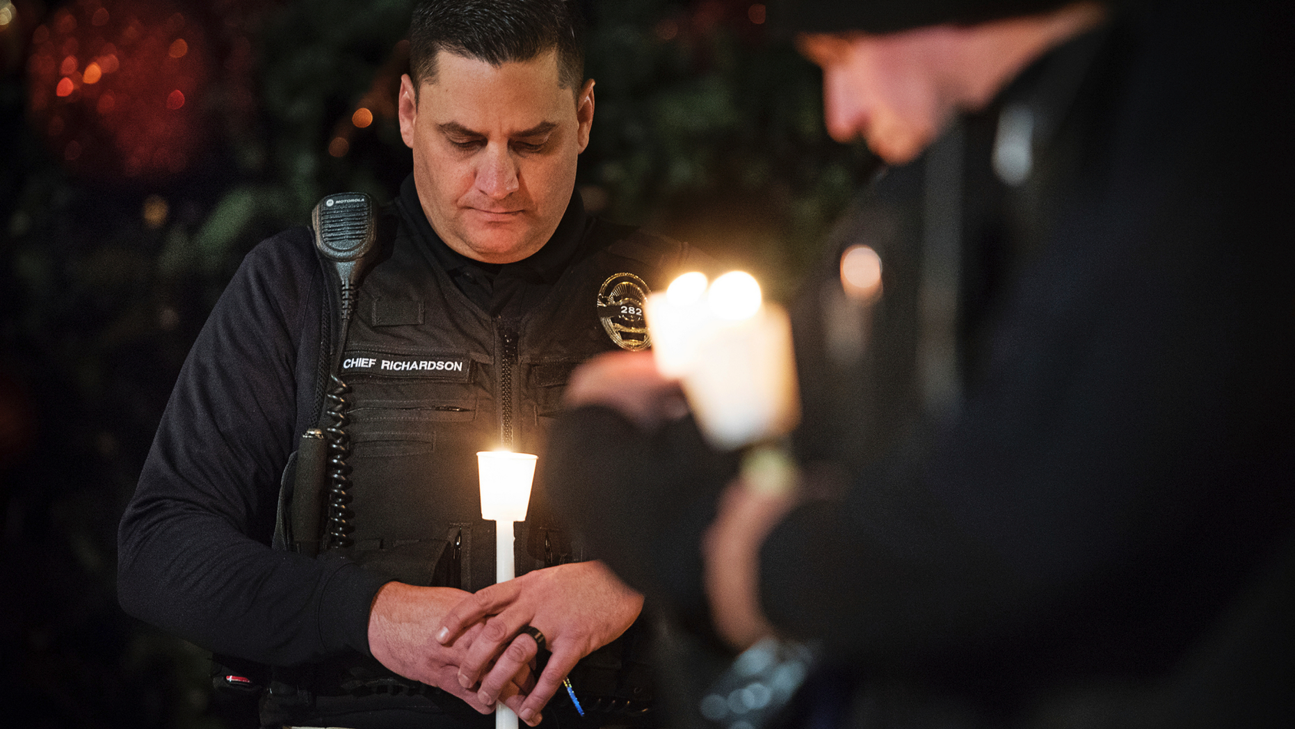 FILE - In this Friday, Dec. 28, 2018 file photo, Newman Police Chief Randy Richardson and hundreds of others attend a vigil in memory of police Cpl. Ronil Singh in Newman, Calif. The Northern California police officer was gunned down during a traffic stop the day after Christmas 2018. (Andy Alfaro/The Modesto Bee via AP,File)