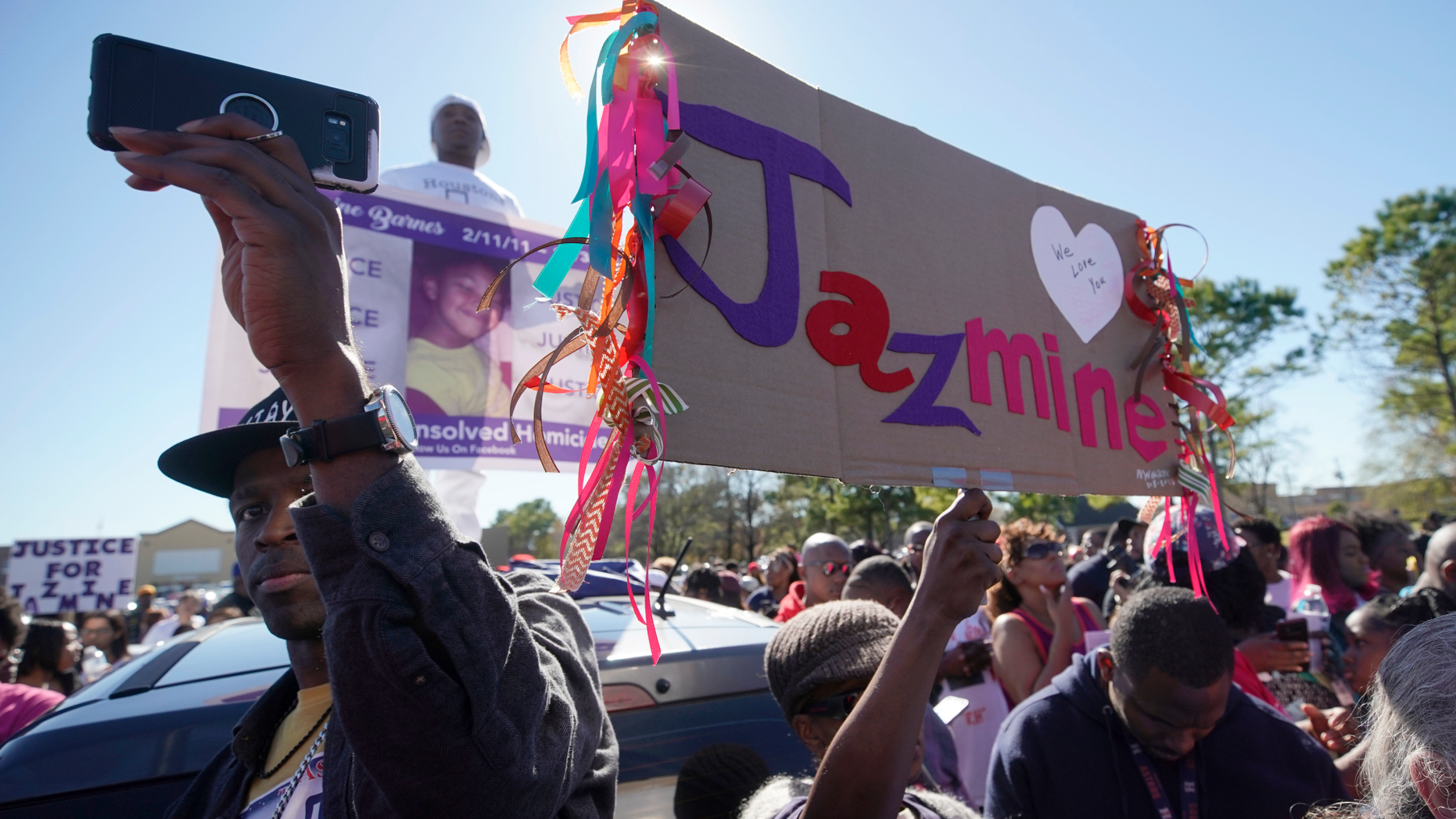 People attend a community rally outside a Walmart on East Sam Houston Pkwy N in Houston on Saturday, Jan. 5, 2019 for 7-year-old Jazmine Barnes, who was killed on Sunday. Jazmine was shot to death nearby while riding in a car with her mother and three sisters. (Melissa Phillip/Houston Chronicle via AP)