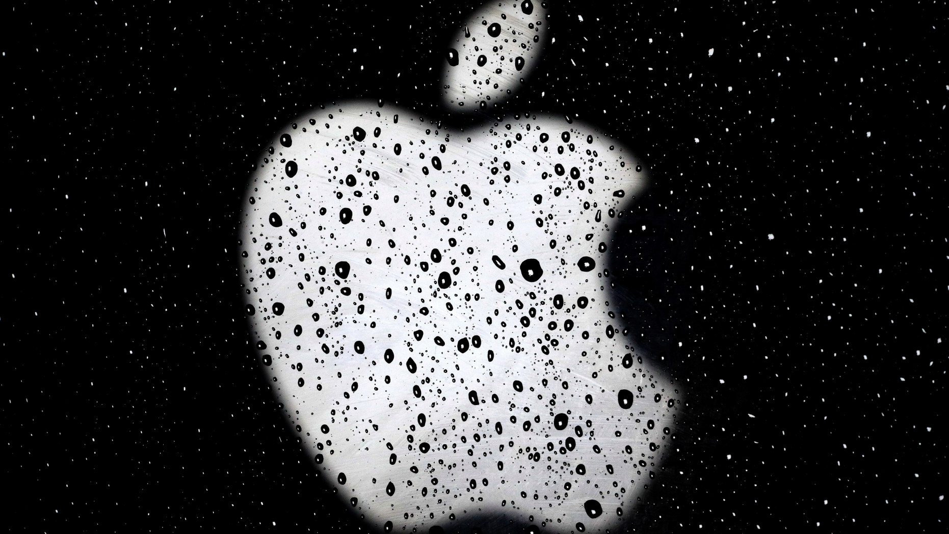 FILE- In this Dec. 26, 2018, file photo an Apple logo is seen in raindrops on a window outside an Apple Store at the Country Club Plaza shopping district in Kansas City, Mo. (AP Photo/Charlie Riedel, File)