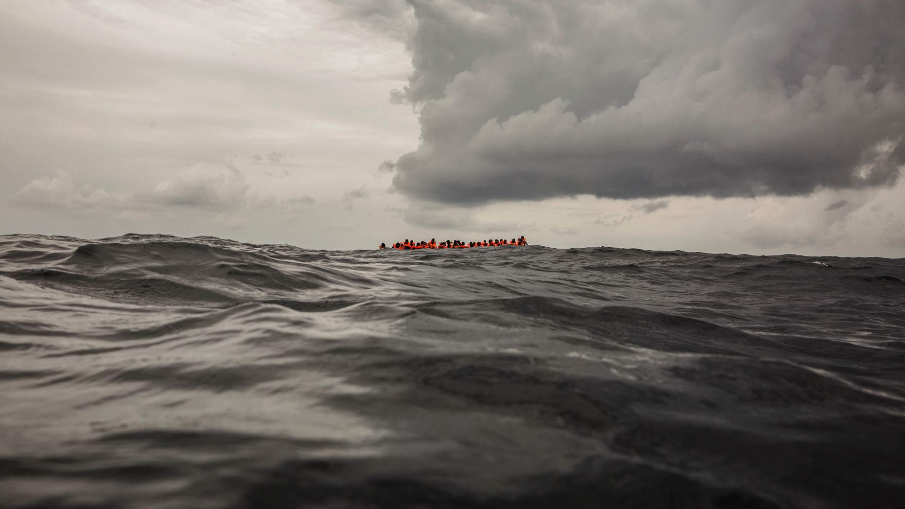 In this Feb. 18, 2018, file photo, refugees and migrants wait to be rescued by aid workers 60 miles north of Al-Khums, Libya. (AP Photo/Olmo Calvo, File )