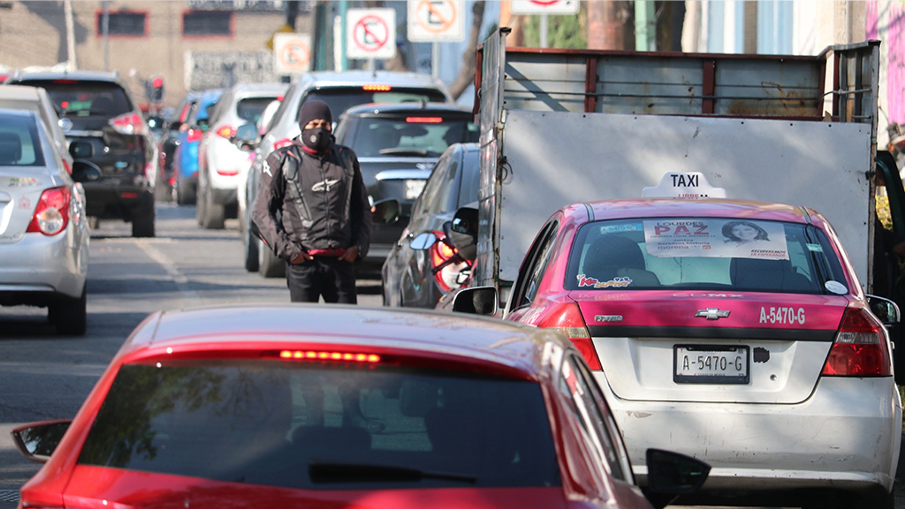 A biker takes a breather waiting in line for fuel in Mexico City