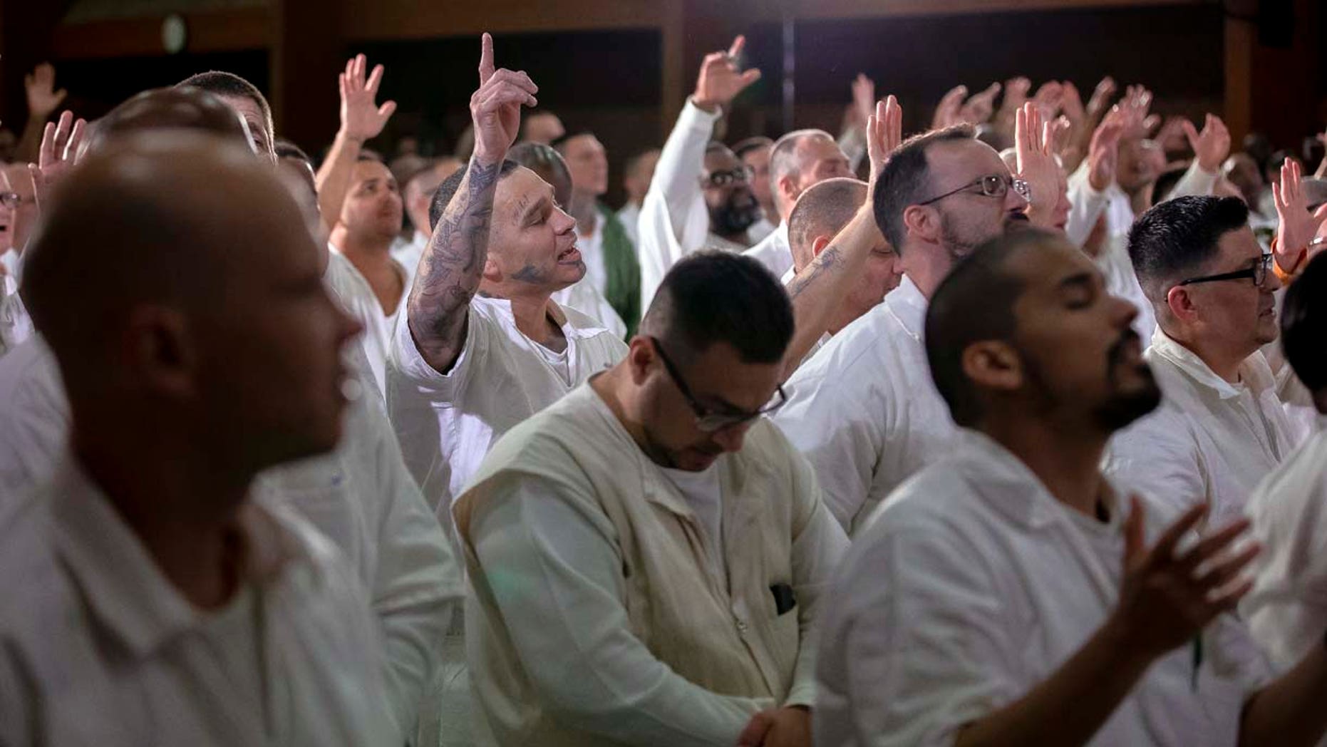 Inmates at the Coffield Unit, a maximum security prison in Anderson County, Texas, worship during a church service. They are part of the newest campus for Gateway Church of Dallas, Texas.