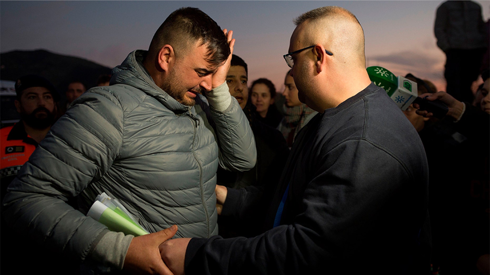 Jose Rosello (left), father of Julen who fell down a well, crying Wednesday as rescue efforts continue to find the boy in Totalan, southern Spain. (JORGE GUERRERO/AFP/Getty Images)